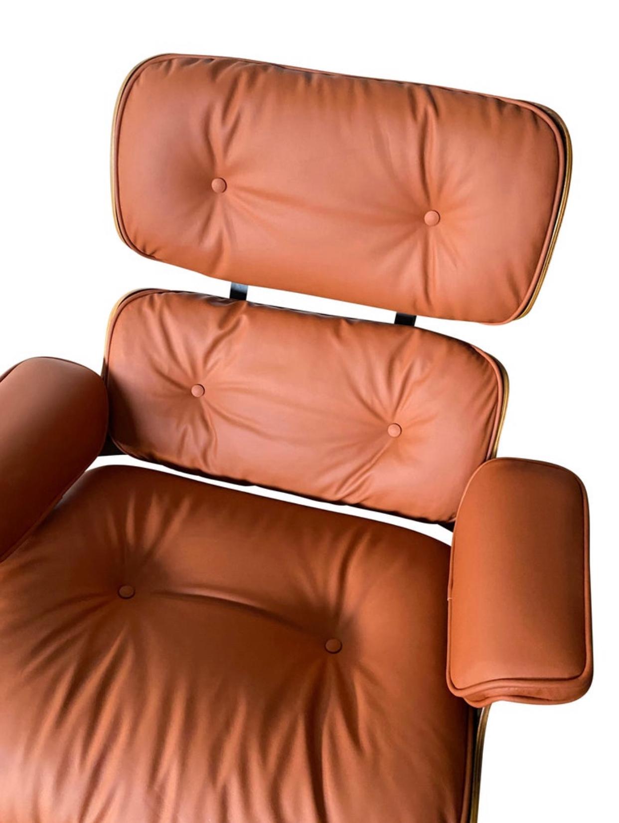 Beautiful custom edition of the iconic Eames lounge chair and ottoman. Rosewood shells and aluminum bases cradle the custom burnt orange leather cushions. New leather very soft and in excellent condition. This color is supremely rare. Chair signed