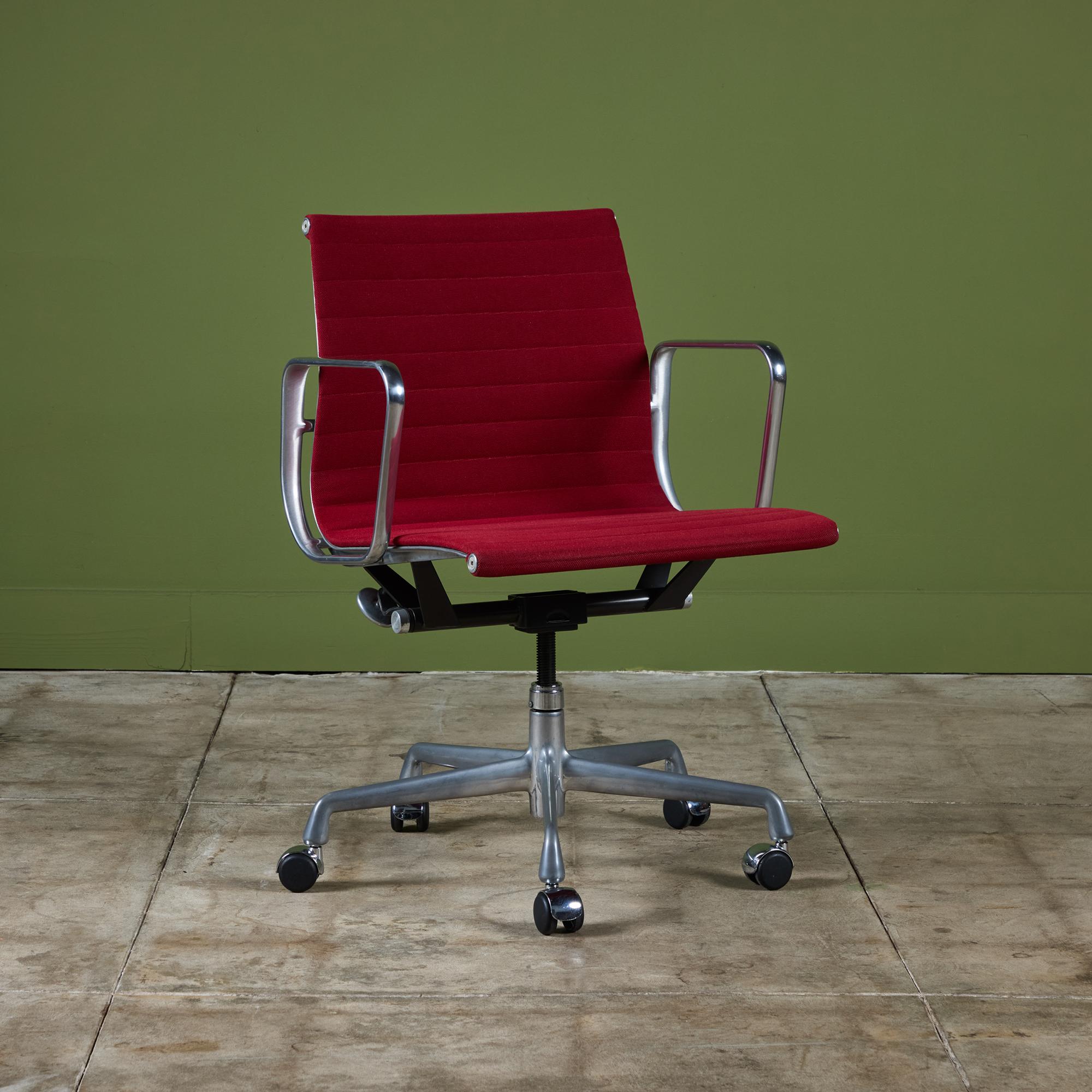 Office chair by Charles and Ray Eames for Herman Miller, c.1990s, USA. From the Aluminum Group, this Management Chair, originally designed in the 1950s features a red upholstered seat with an aluminum frame. It rests on a five star base with casters