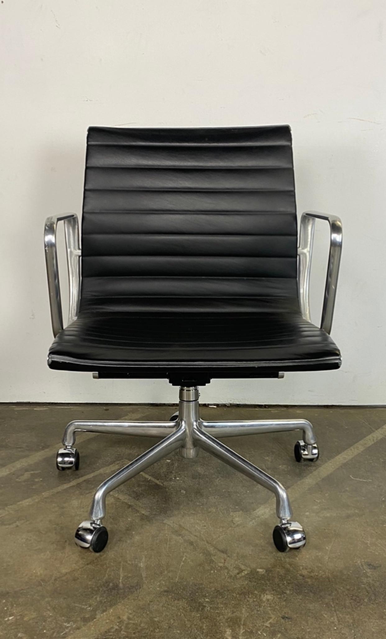 Gorgeous edition of the classic Eames office chair for Herman Miller. Management armchair is executed in polish aluminum and black leather. Minimal wear from age and yes. The arms are in better than average condition and everything is in perfect