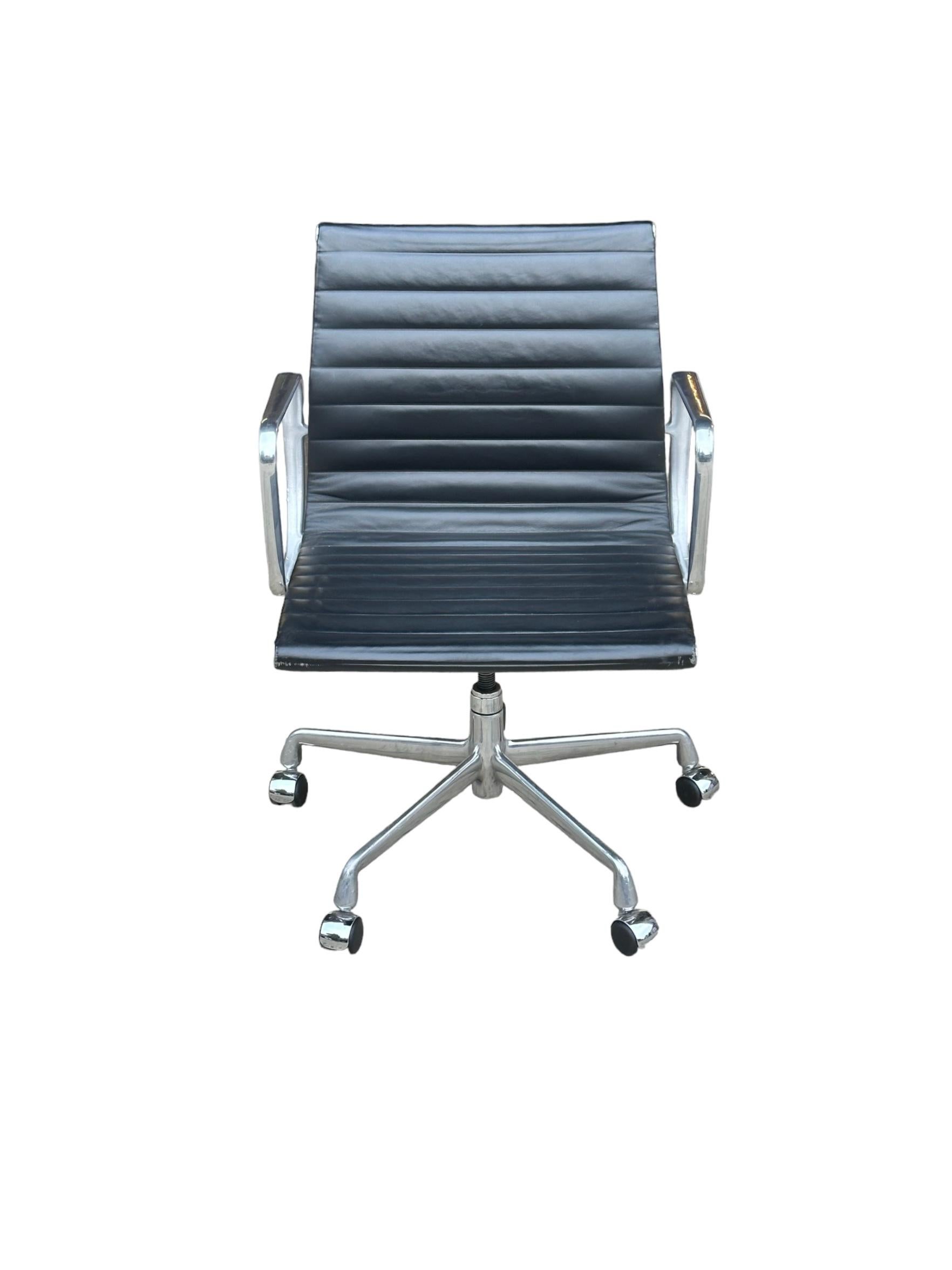 Gorgeous edition of the classic Eames office chair for Herman Miller. Management armchair is executed in polish aluminum and black leather. Minimal wear from age and use. The arms are in better than average condition and everything is in perfect