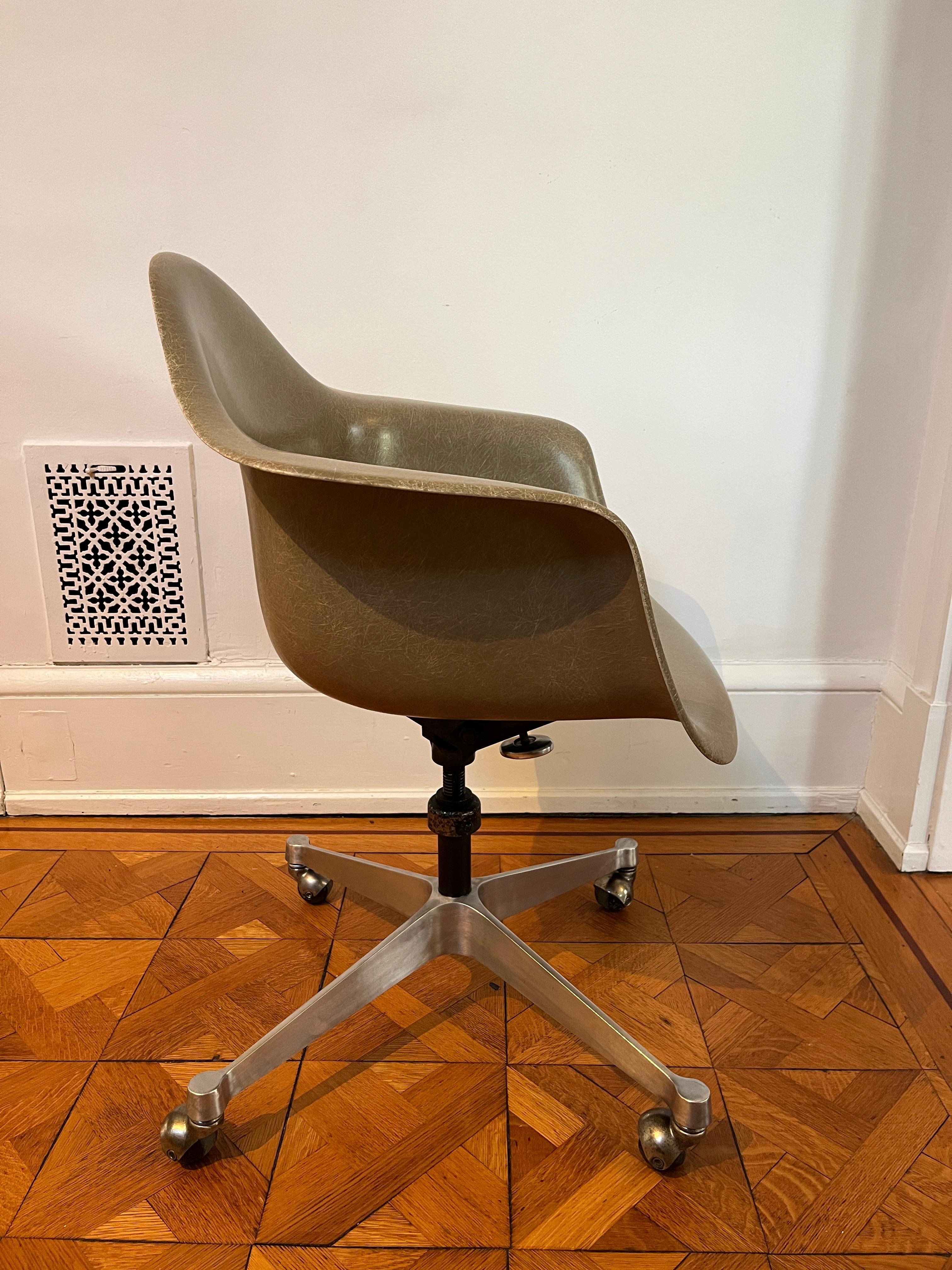 Molded Fiberglass task armchair by Charles and Ray Eames for Herman Miller. Classic (fourth generation 1958-1993) fiberglass shell chair on four-star aluminum base with original casters. Fiberglass shell is in excellent condition and base is in very