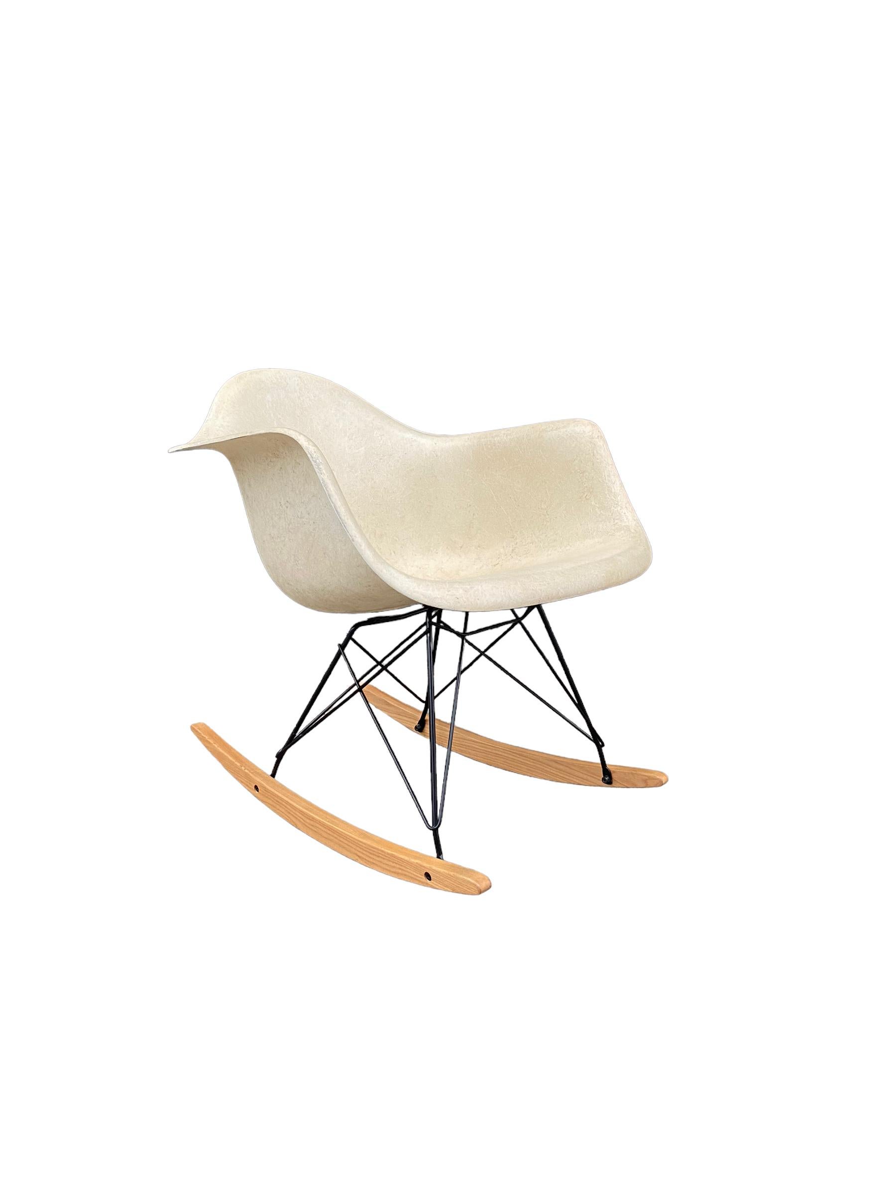 Parchment fiberglass RAR rocking chair by Charles and Ray Eames and manufactured by Herman Miller. Clean shell with no cracks or holes. Signed Herman Miller and guaranteed authentic. Rocking base with black rod frame and wood rails. Timeless mid