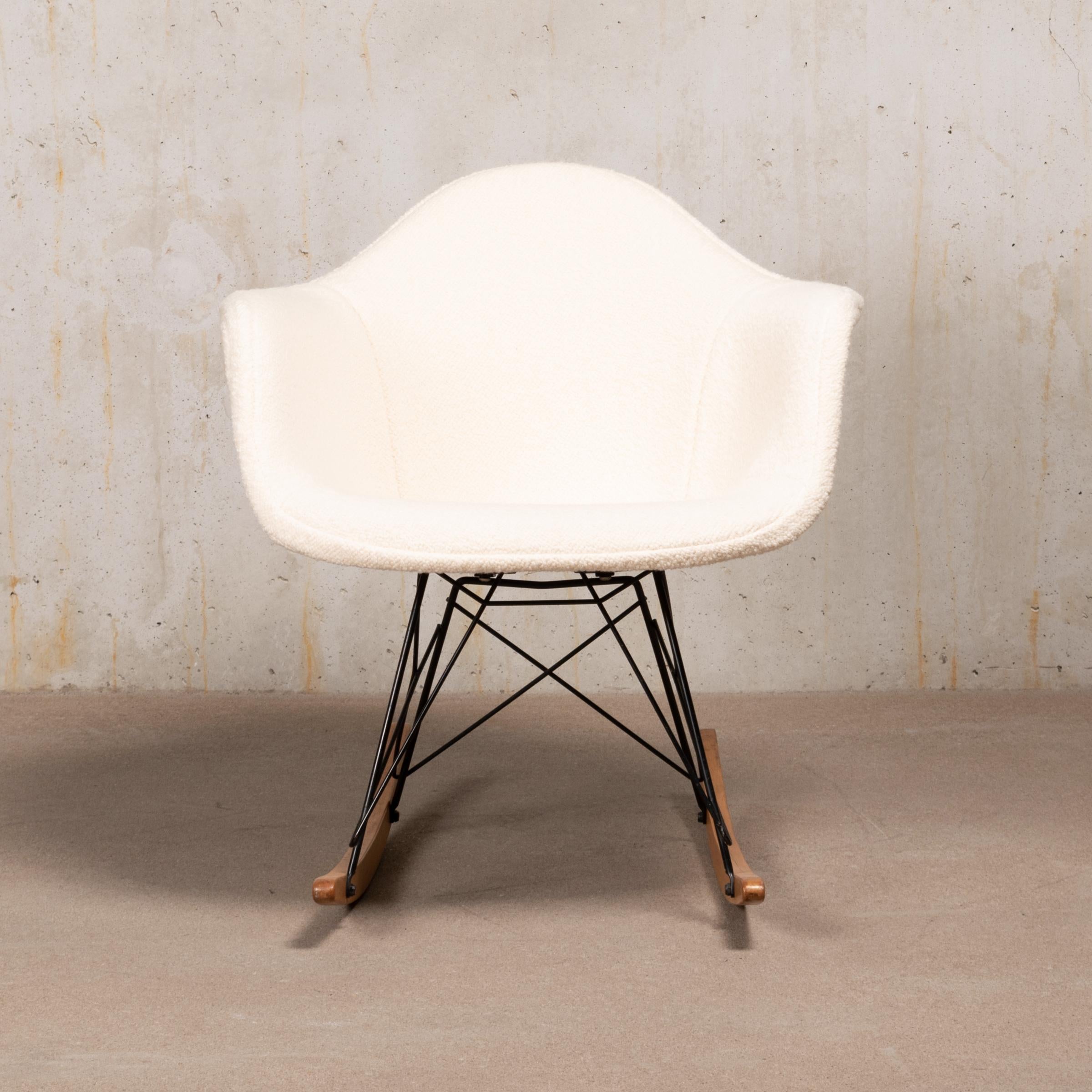 Beautiful and iconic mid-1950s RAR rocking armchair in very good condition by Charles and Ray Eames. Newly upholstered in premium Dedar Bouclé white wool and with original base and runners! Signed with embossed factory logo (Zenith plastics).