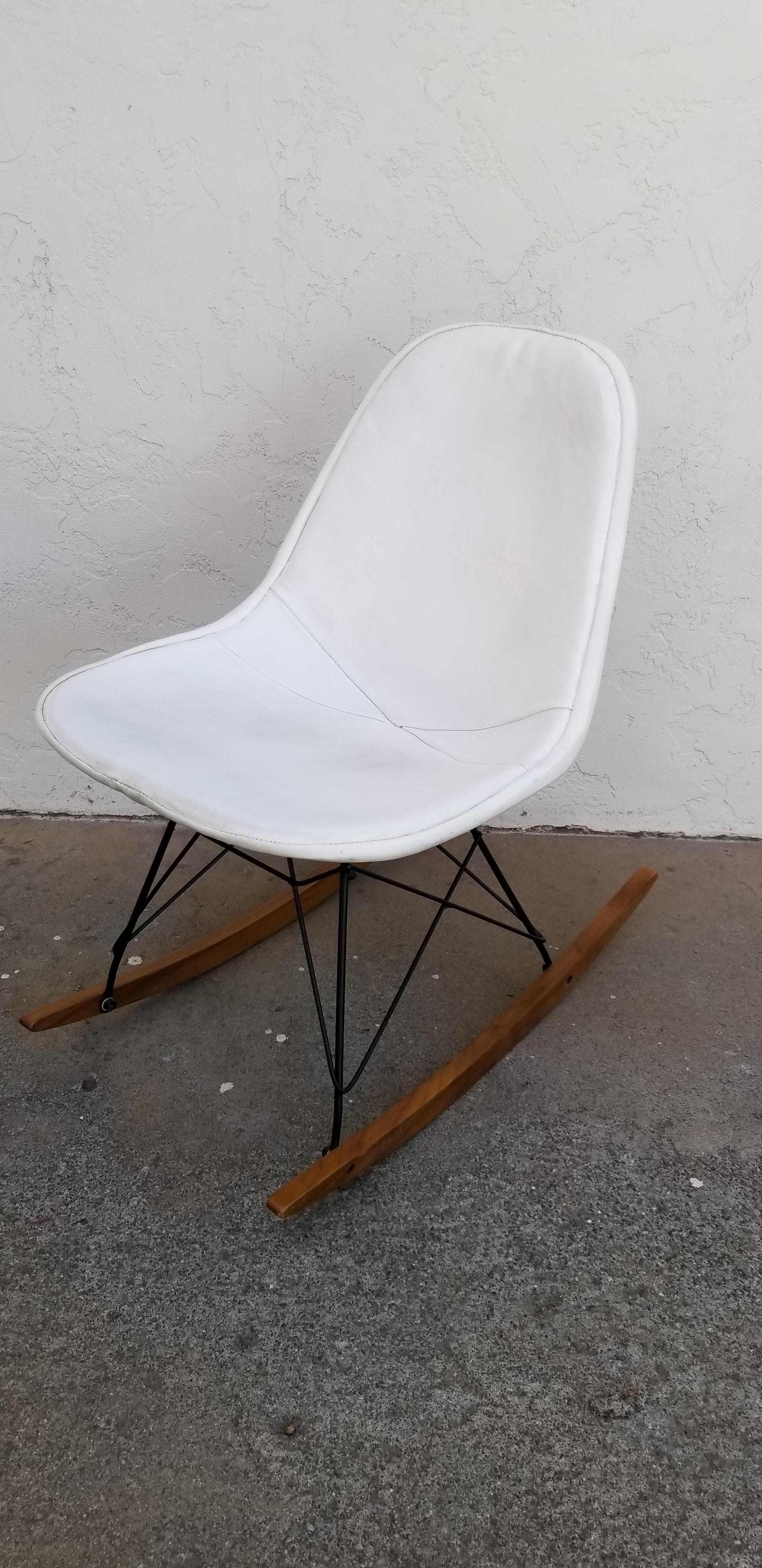 Vintage Herman Miller seat with original Naugahyde cover. Wire base is an aftermarket, replacement. Bold black and white contrasting colors. Age appropriate wear to Naugahyde. An opportunity to have a classic and scarce Eames wire rocker without