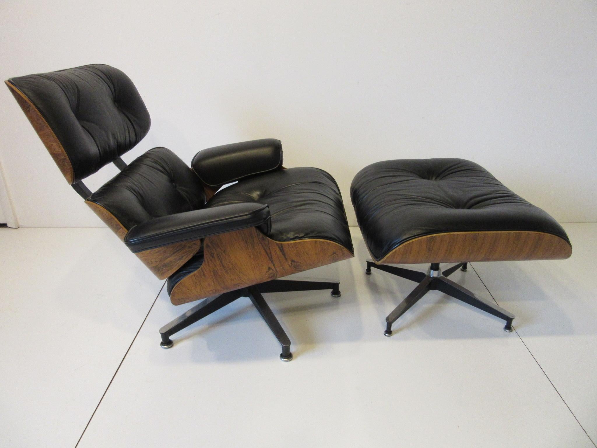 A soft black leather cushioned 670 lounge chair and 671 ottomans with well flamed, rich and rare Brazilian rosewood shell. Having cast aluminum star bases to both pieces and still retaining the manufactures labels from the Herman Miller furniture