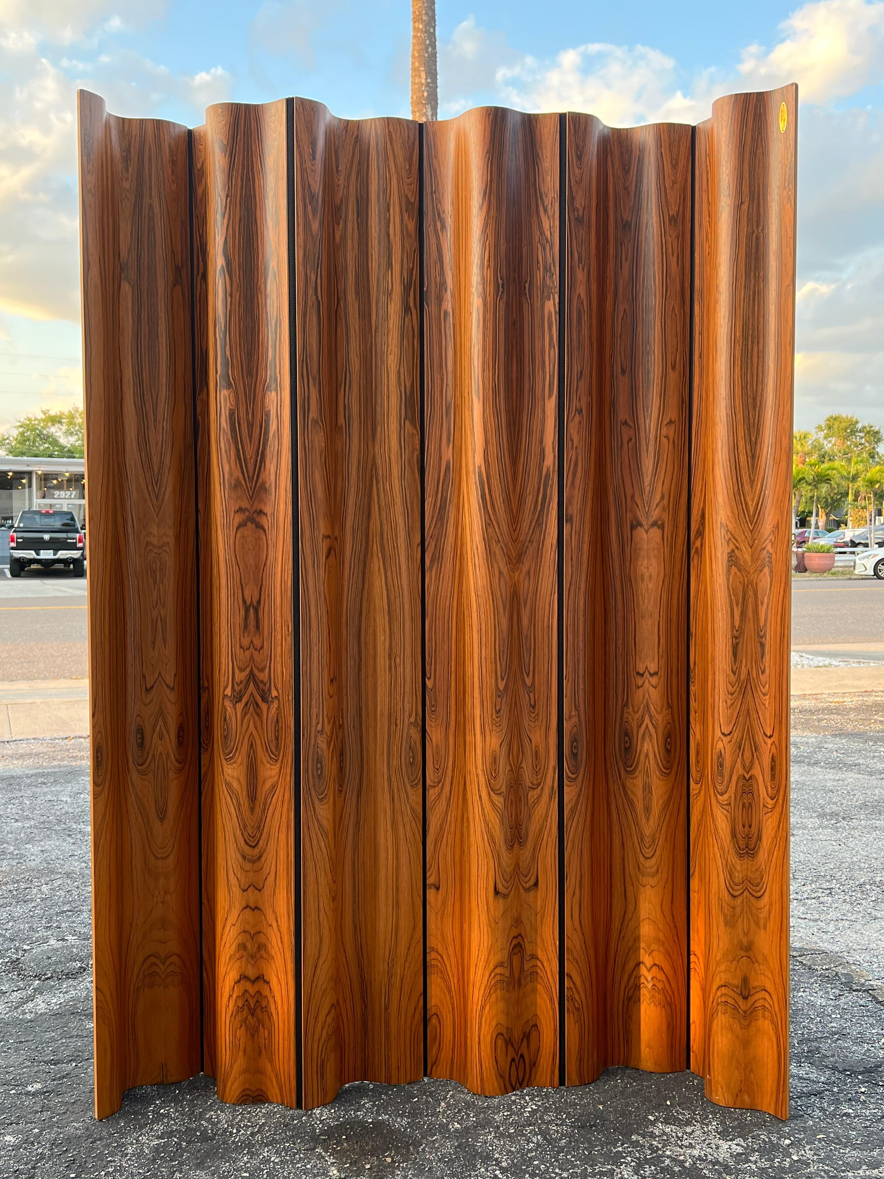 Limited edition of the Eames folding screen (FSW-6) in rosewood, numbered 107/500. The design of the screen was a clever combination of molded plywood panels and a flexible cotton canvas band in between each. The panels were shaped to the same exact