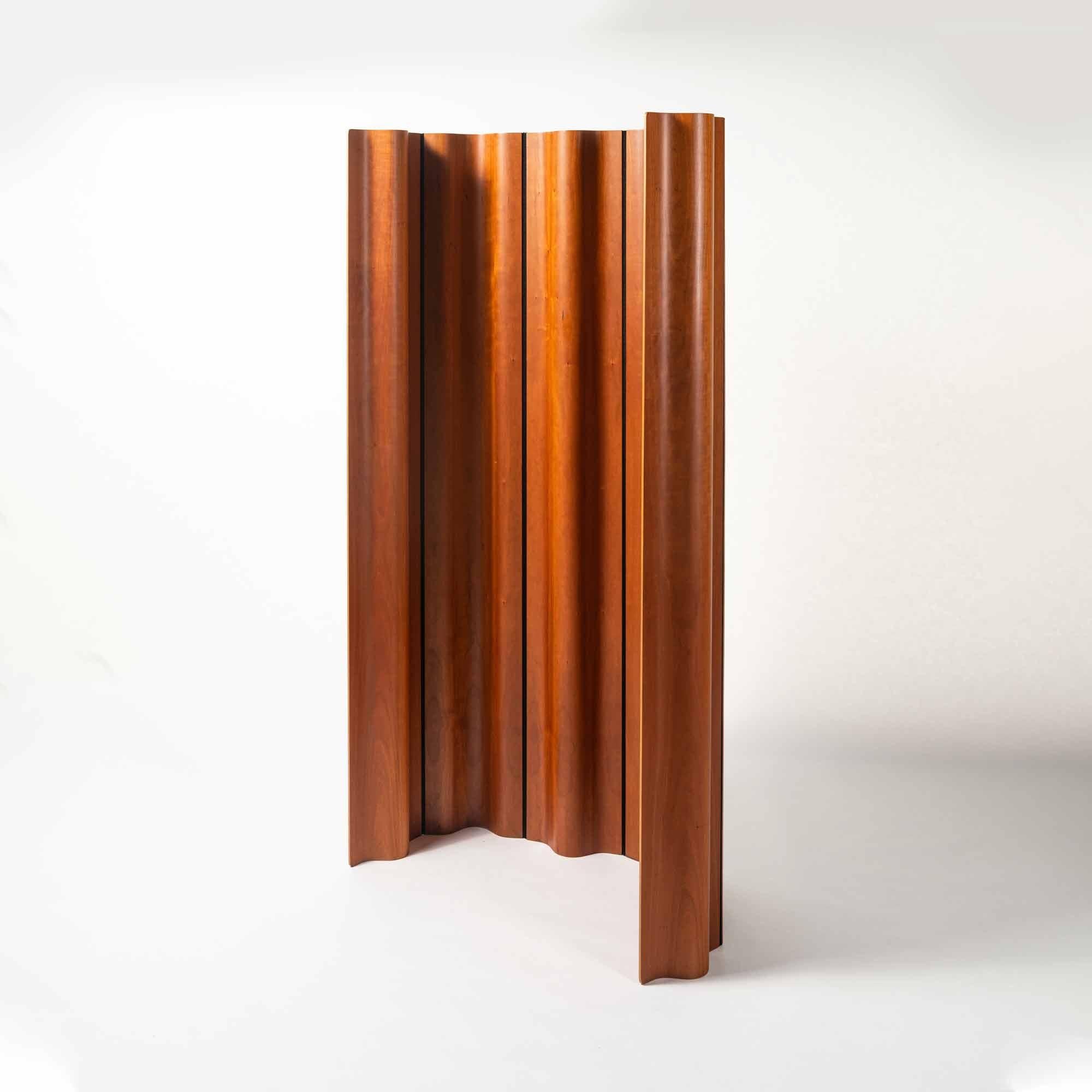 Newer edition of the Eames folding screen (FSW-6) in cherry wood, circa 1990s. The design of the screen was a clever combination of molded plywood panels and a flexible cotton canvas band in between each. The panels were shaped to the same exact