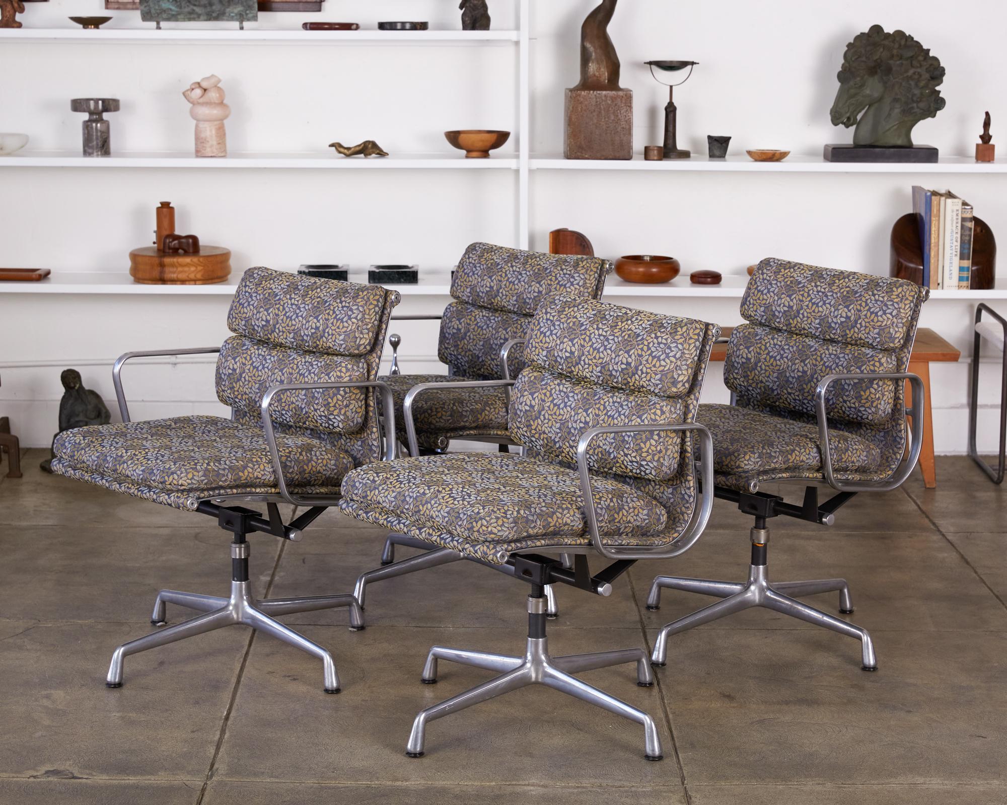 A descendant of the Aluminum Group, these soft pad management chairs were designed in 1969 and are cushier than their counterparts. These are finished in a foliage print fabric with a royal blue background and green, yellow and white flowers. Their