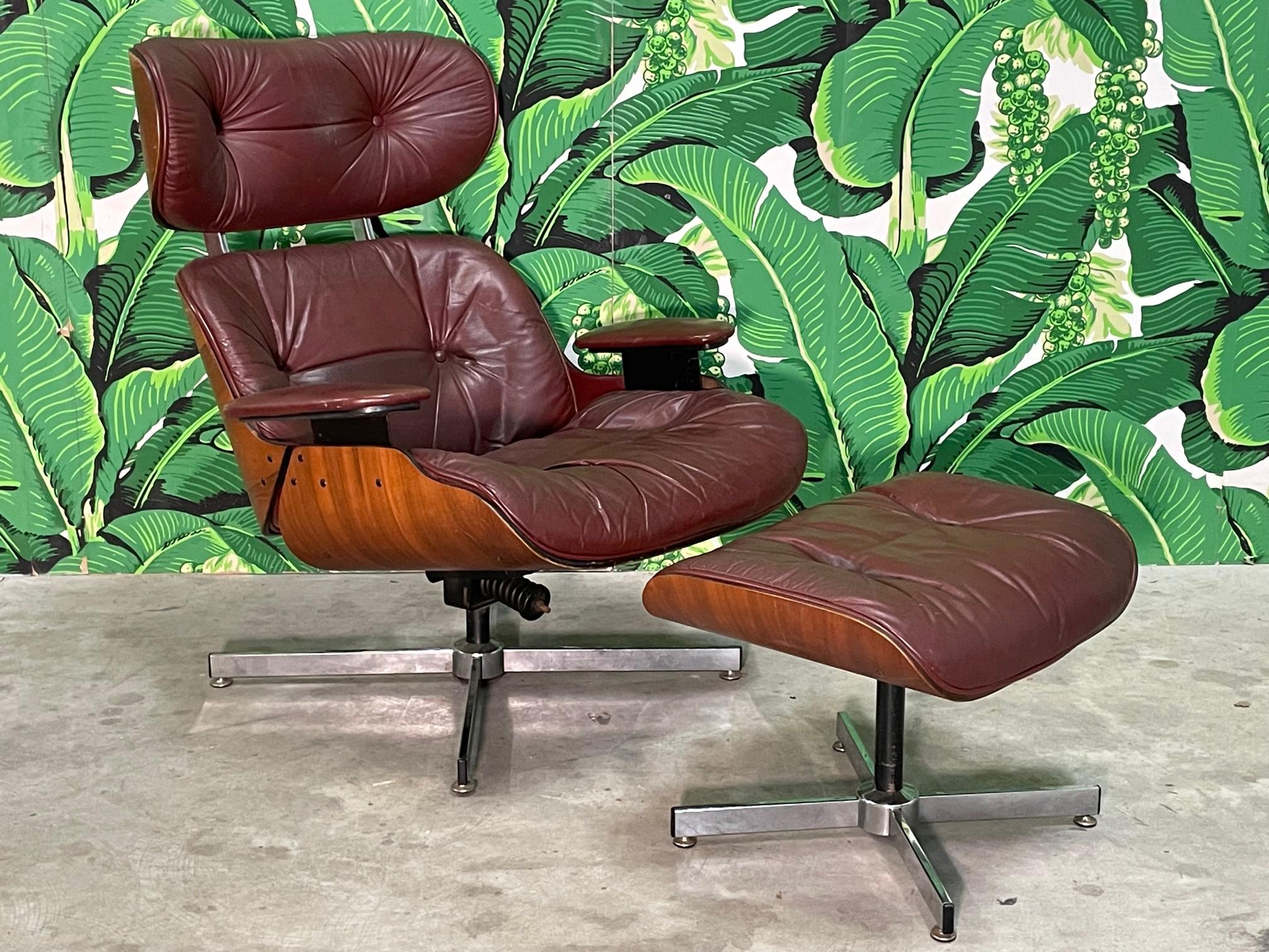 Mid century lounge chair and ottoman feature the iconic Eames style with leather upholstery and signature curved wood frame. Good condition with imperfections consistent with age and use, namely there are two buttons missing on ottoman and one
