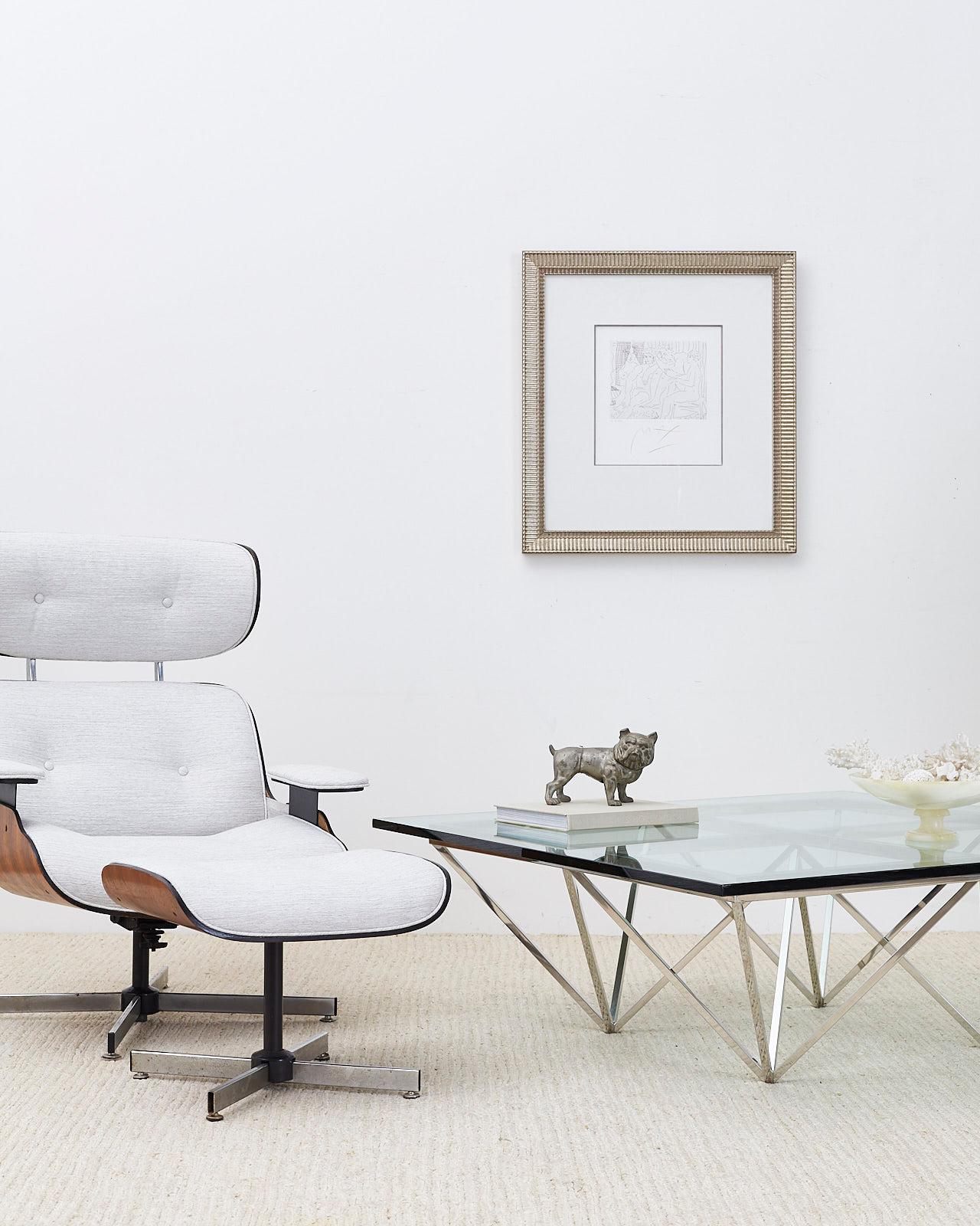 Stylish reupholstered swivel lounge chair and ottoman made in the manner and style of Charles and Ray Eames by Plycraft. Features a modern redux with a textured light gray fabric. Tufted seating surfaces with the iconic lounge chair profile. Ottoman