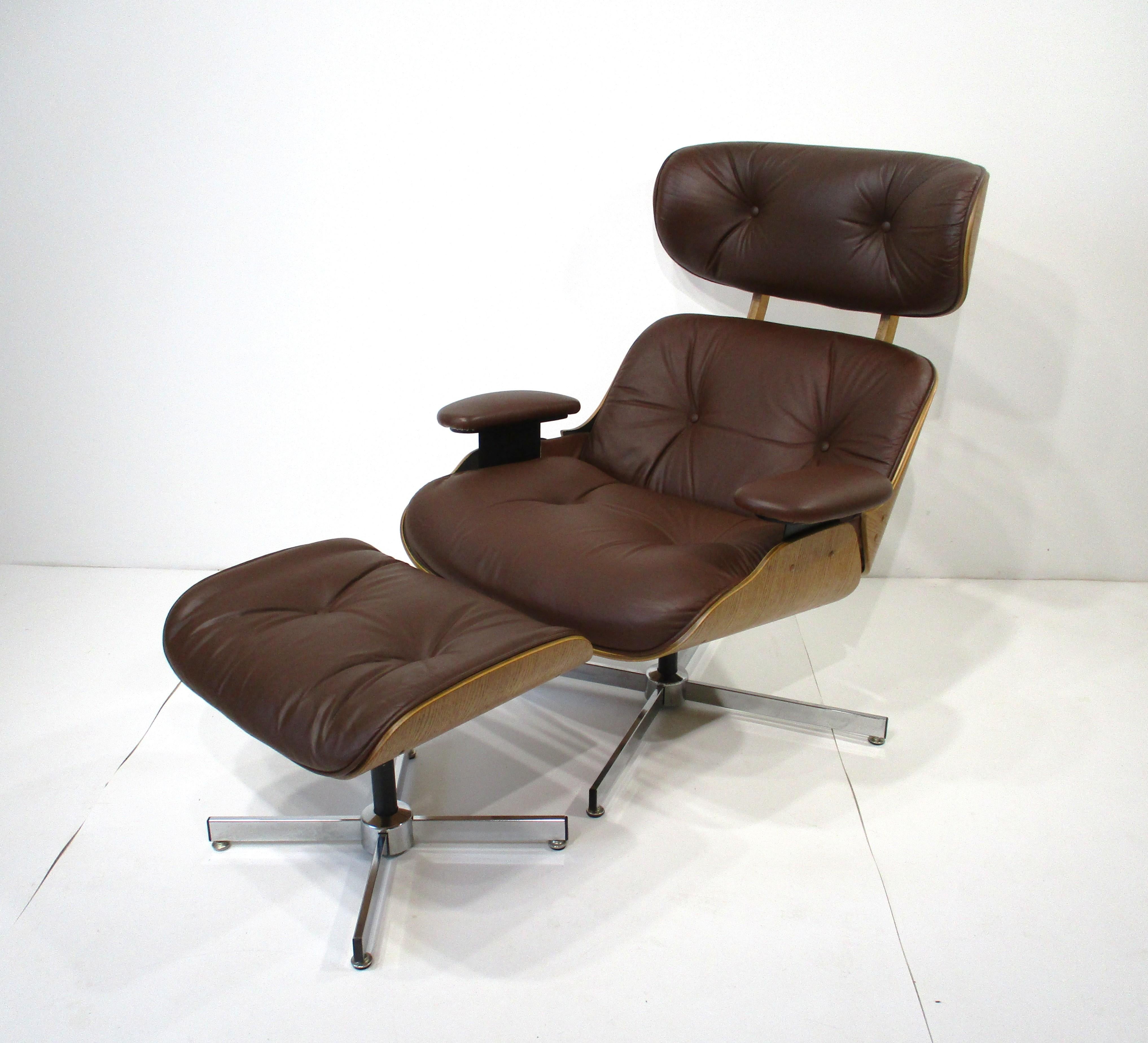 A Mid Century lounge chair with ottoman in cognac leather with lighter oak wood molded frame and chromed metal bases. This model has an adjustable spring to the bottom for rocking and rake, unlike the Eames model which has a set angle and is