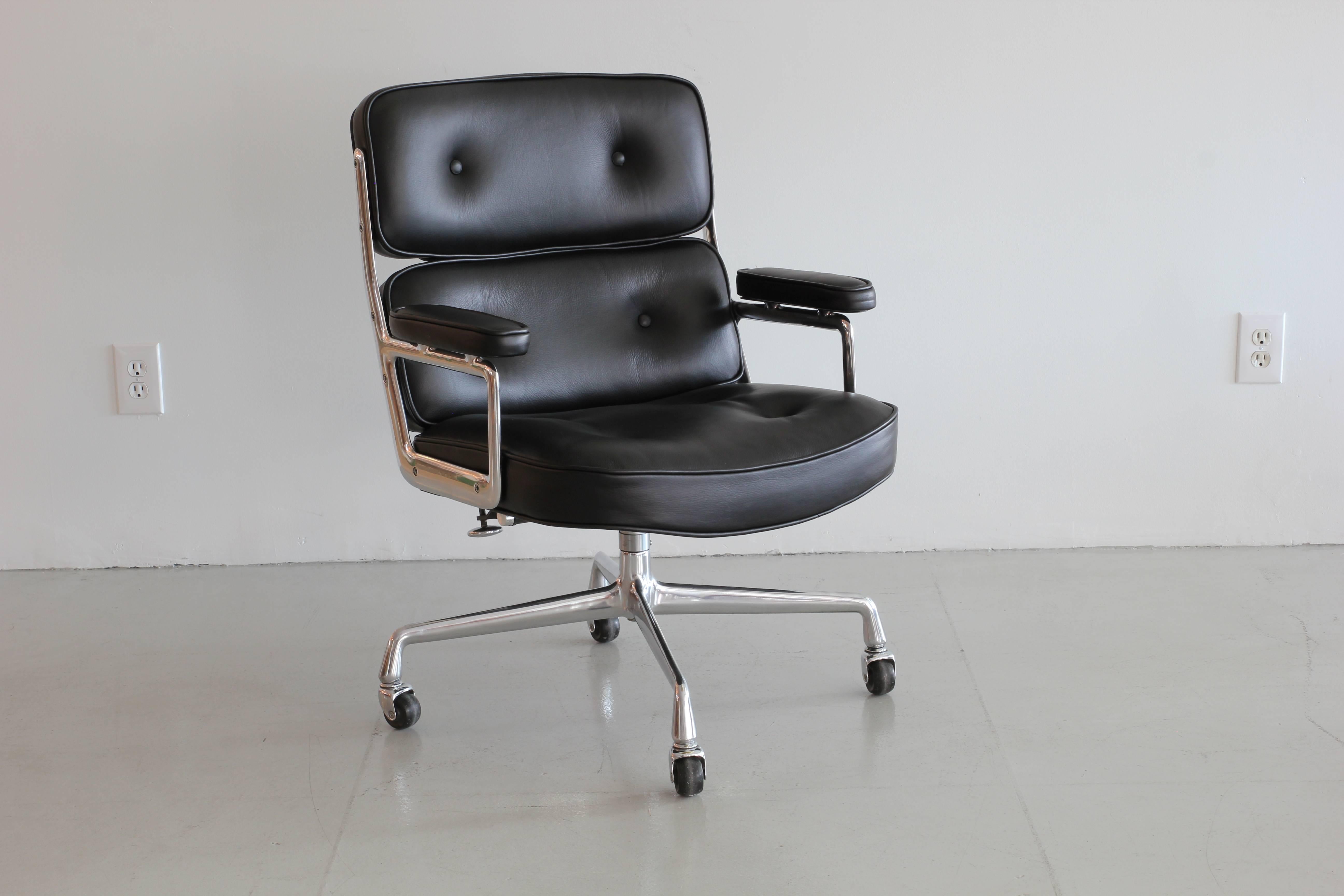 Classic office chair from the Time Life building in New York. Designed by Eames featuring newly upholsteredl black leather, new casters and a newly polished aluminium base and frame. Chair is height adjustable with tilt and swivel.