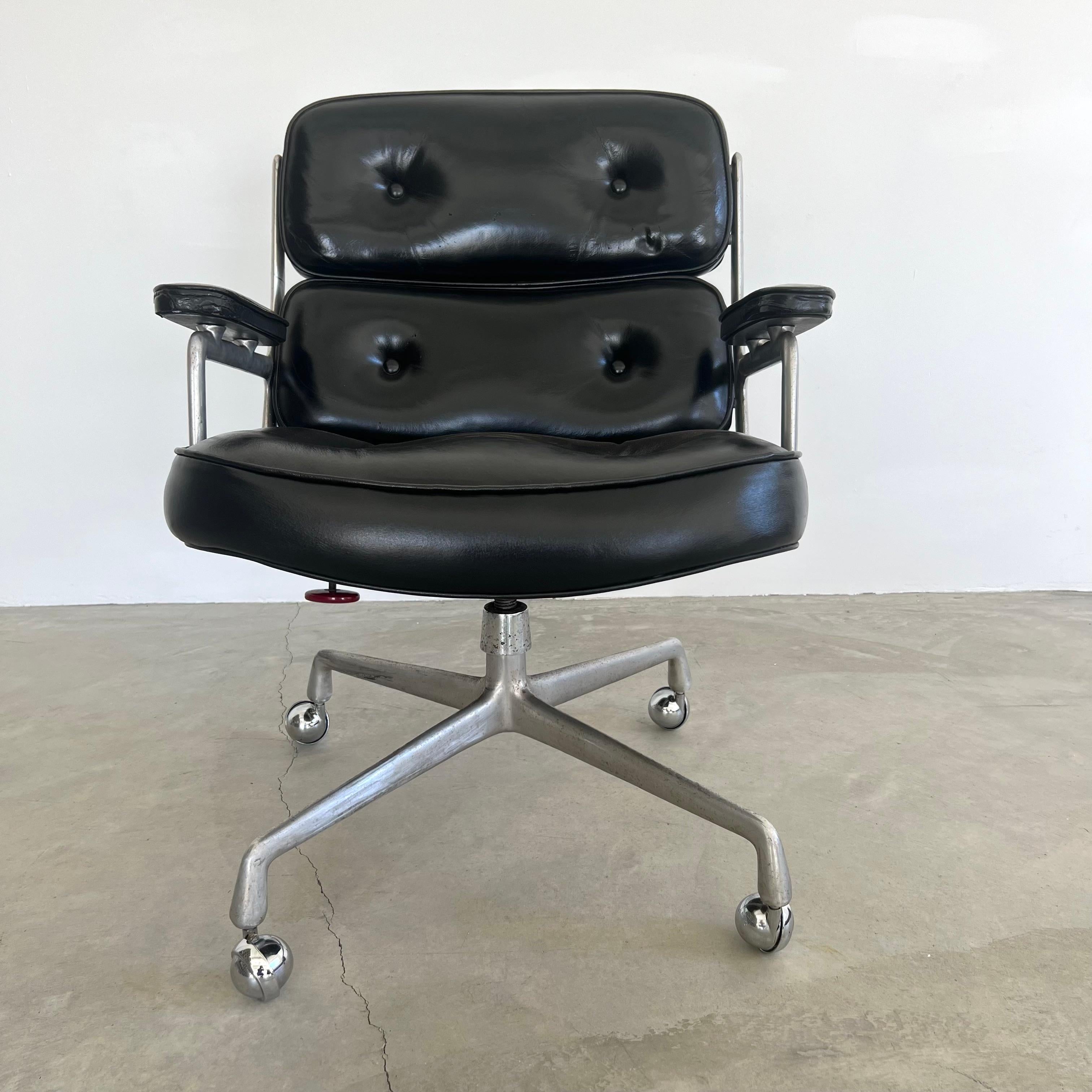 Classic Eames Time Life swivel chair in black leather for Herman Miller. Original black leather with wear as shown. Extremely comfortable and worn in. Chair swivels. Chair reclines. Height is adjustable. Metal bracket added at some point which gives