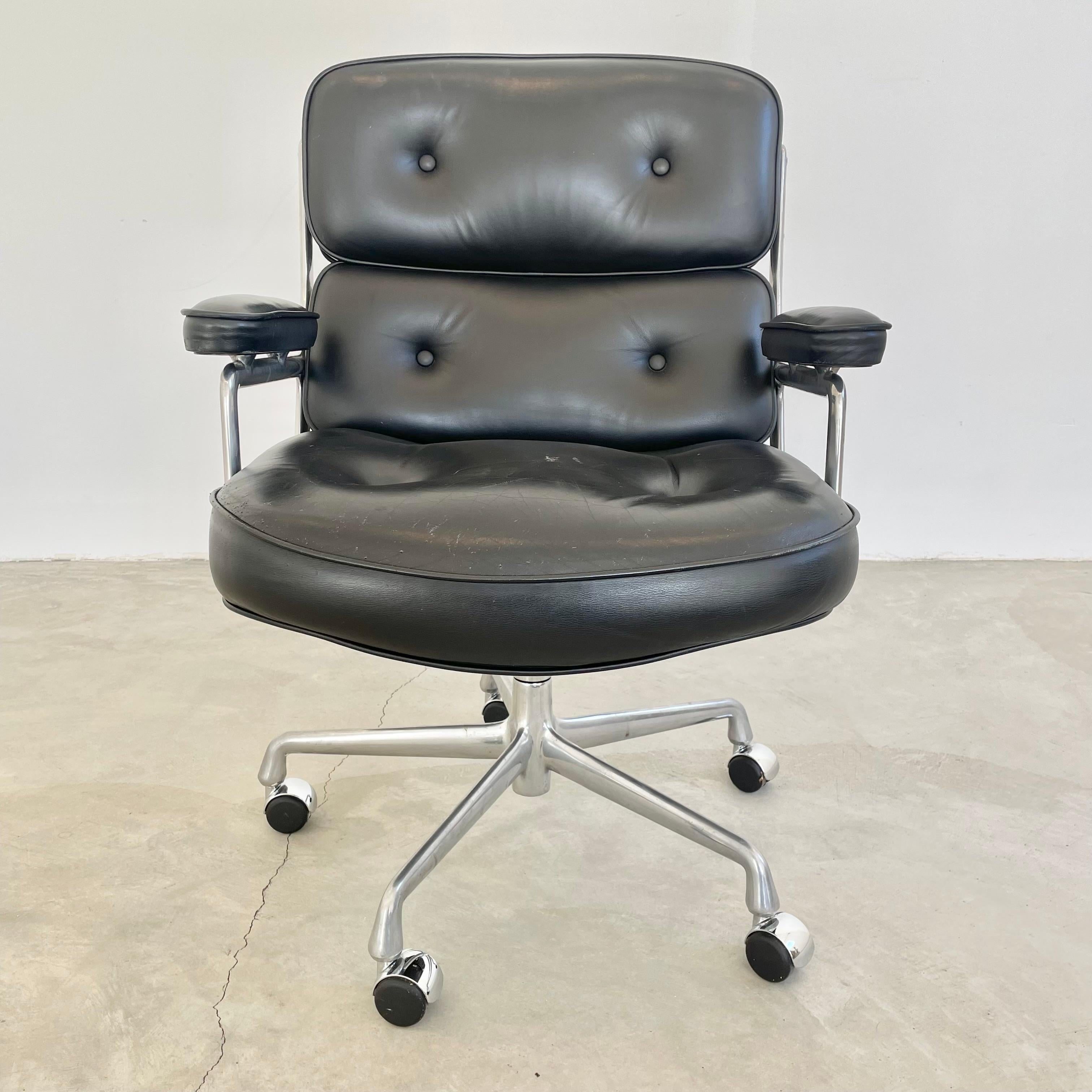 Classic Eames Time Life swivel chair in black leather with an aluminum frame. All original with some wear as shown. Knob under the seat for adjusting recliner as well as the height adjustor. Extremely comfortable. Chair swivels, reclines and is