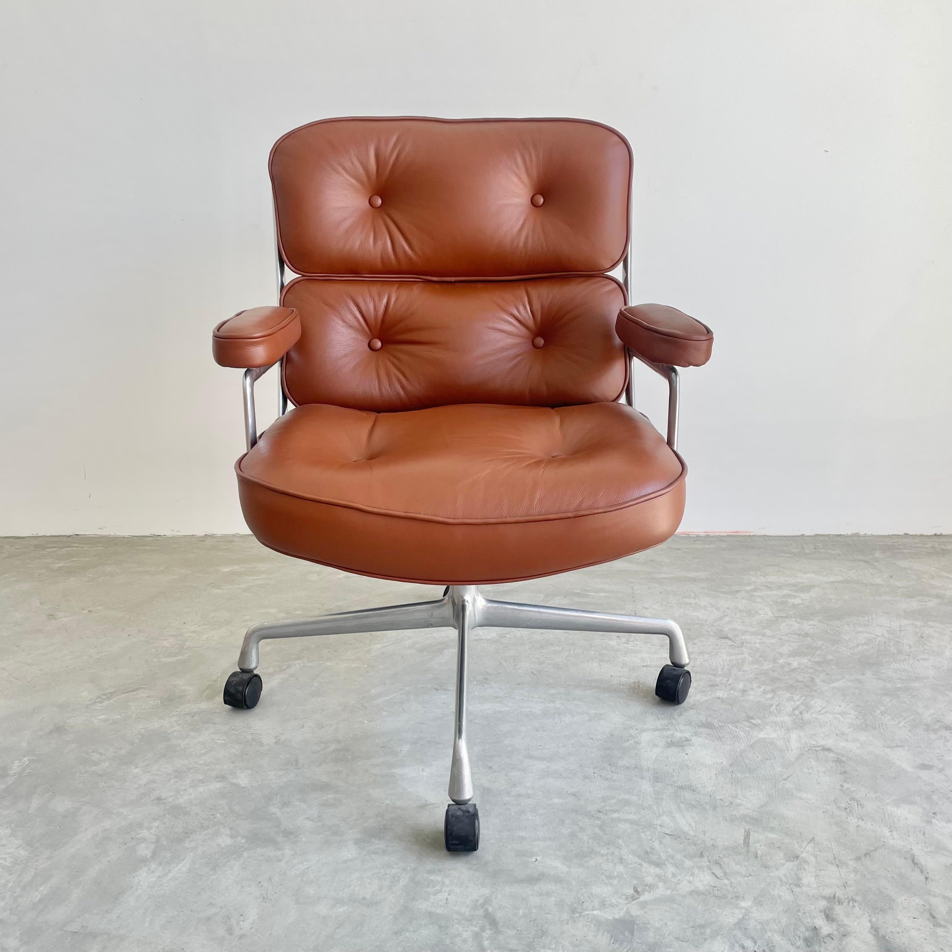 Classic Eames Time Life chair for Herman Miller in brown leather with a polished aluminum frame and legs. Originally designed in 1960 by Charles and Ray Eames for use in the lobby of the Time Life building in New York. 

Recently re-upholstered in a