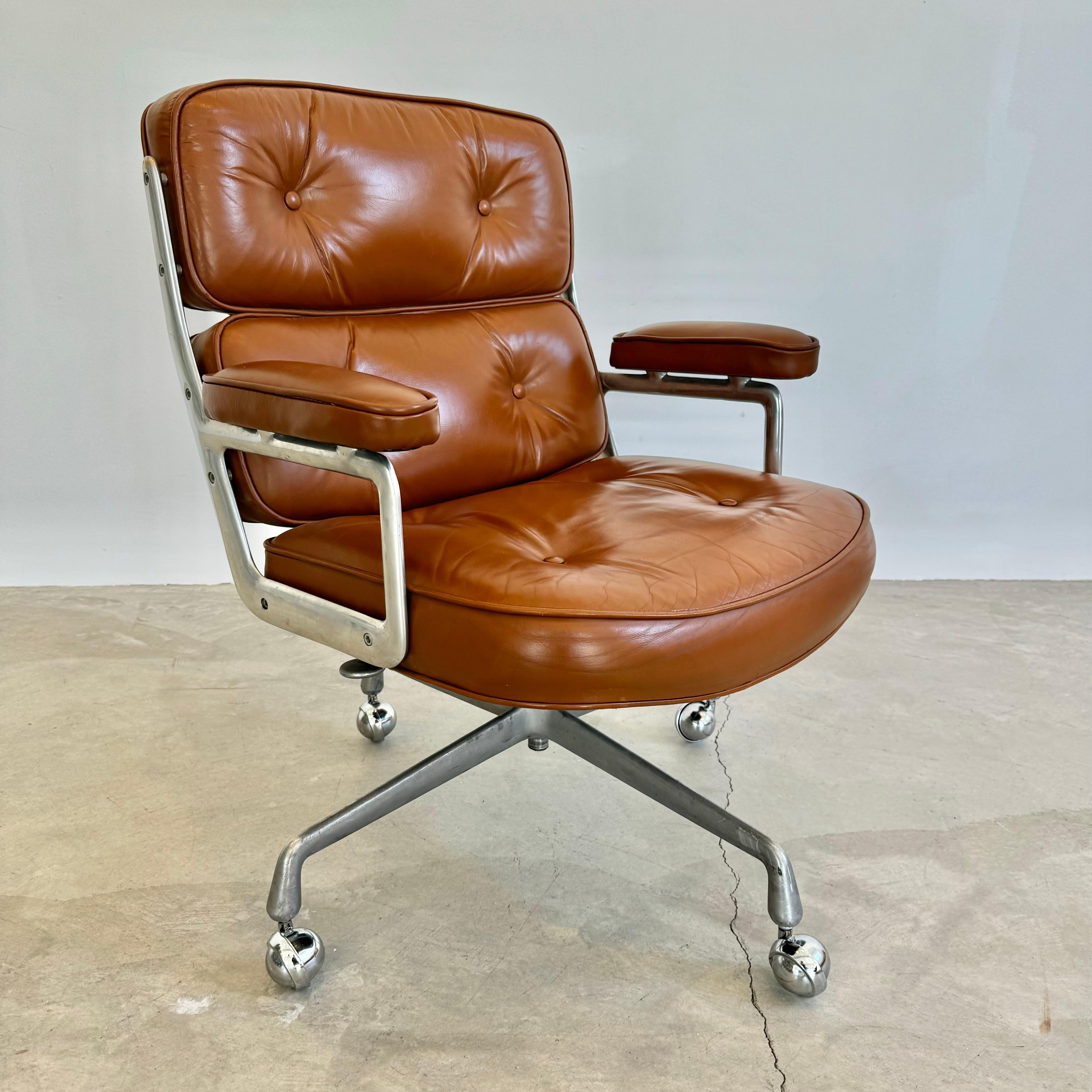 Classic Eames Time Life swivel chair in butterscotch colored leather for Herman Miller. Original leather with wear as shown. Extremely comfortable and worn in. Chair swivels. Chair reclines. Height is adjustable. 4 star base. Original Herman Miller