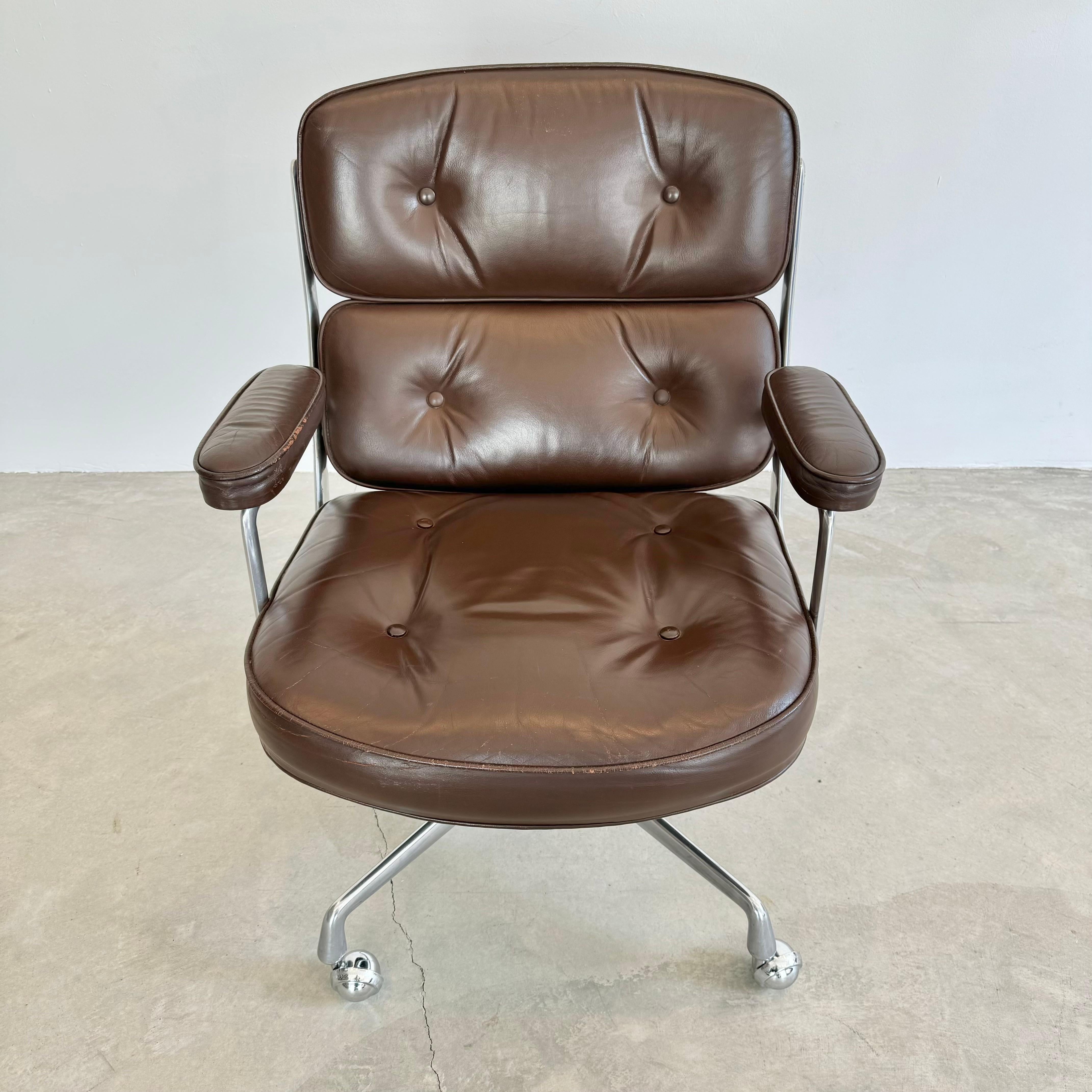 Classic Eames Time Life swivel chair in chocolate brown leather for Herman Miller. Original black leather with only slight wear as shown. Metal in good condition. Extremely comfortable and worn in. Chair swivels. Chair reclines. Height is
