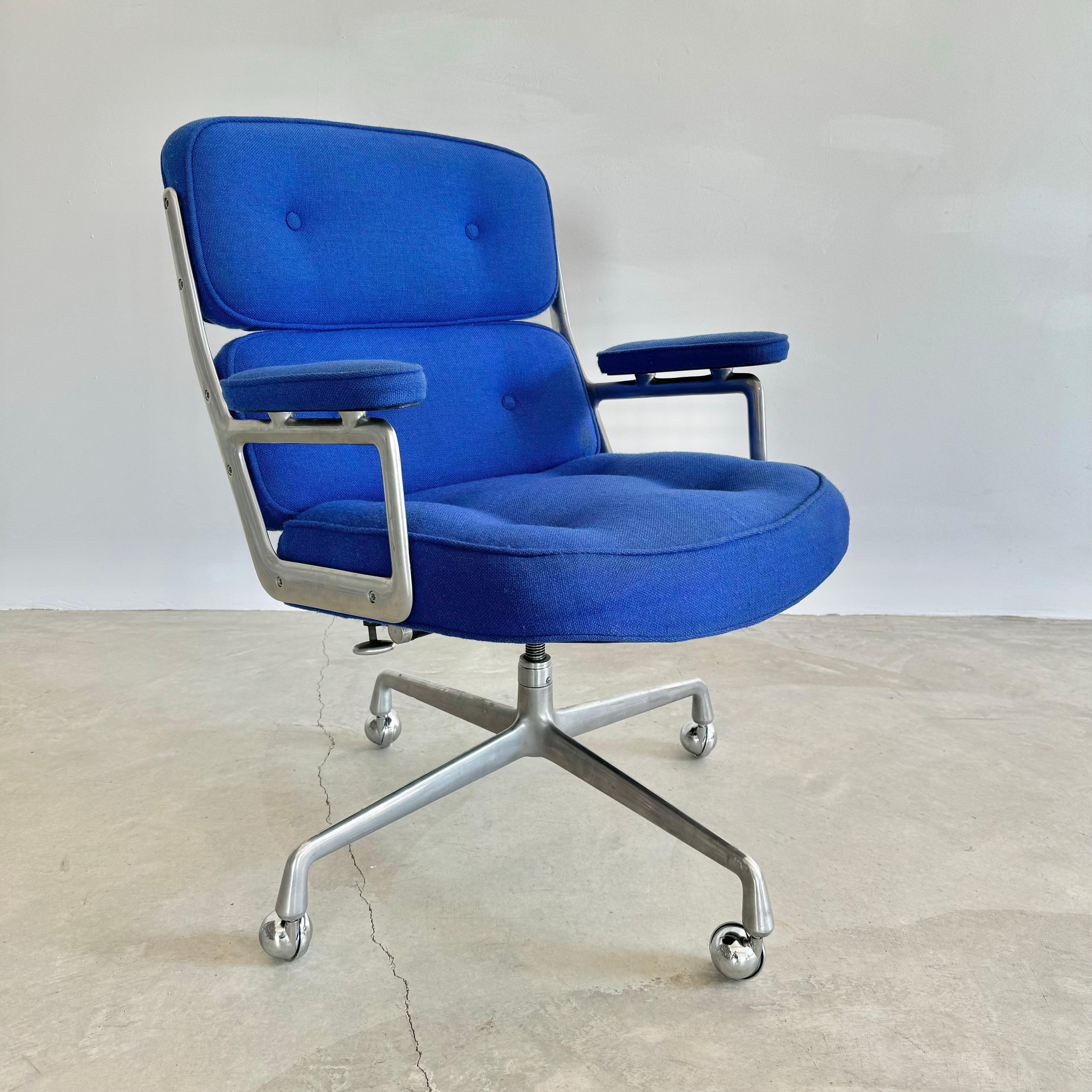 Classic Eames Time Life swivel chair for Herman Miller in rarely seen original navy blue burlap upholstery. Chair swivels and reclines and is height adjustable. Metal and burlap are in good condition with appropriate wear with age as shown. Original
