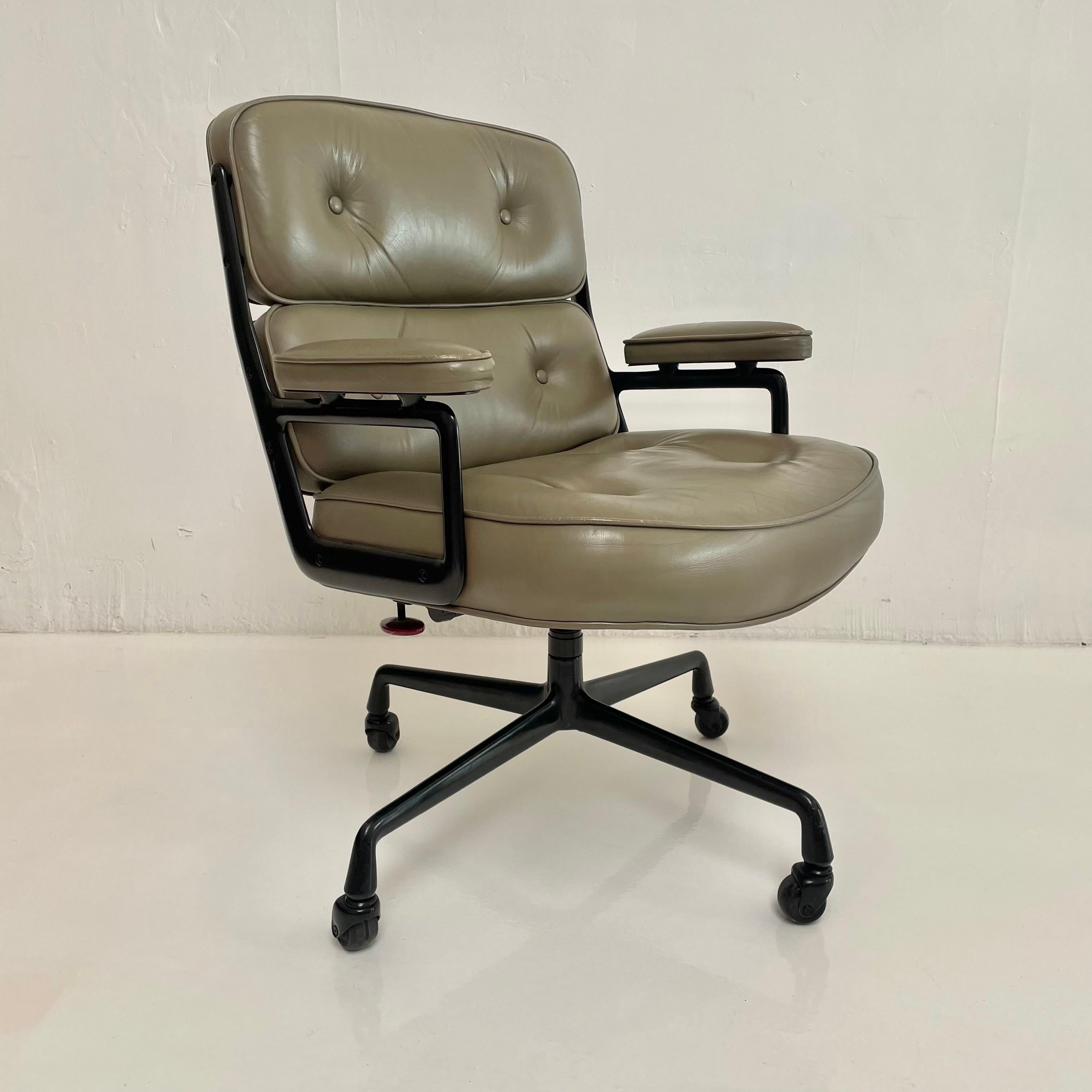 Classic Eames Time Life Chair in olive leather for Herman Miller, circa 1984. Olive-coloured leather with wear as shown. Extremely comfortable and worn in. Chair swivels and reclines. Height is adjustable. Rarely seen black powder coated metal frame