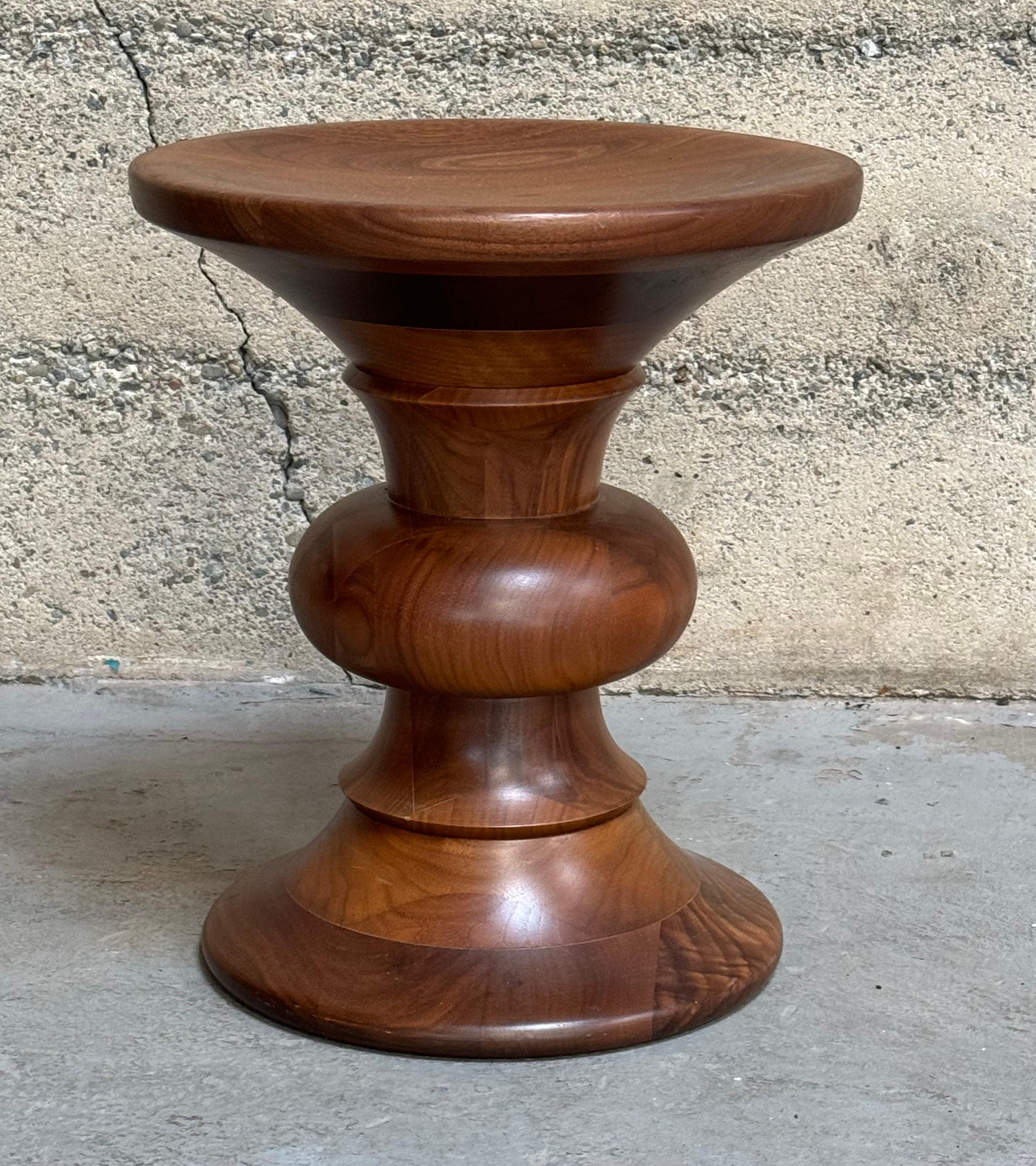 Times Life stool model  designed by Ray and Charles Eames for the Time Life Building during the 1950s, crafted from turned solid walnut. These are newer production pieces, rich color and graining.