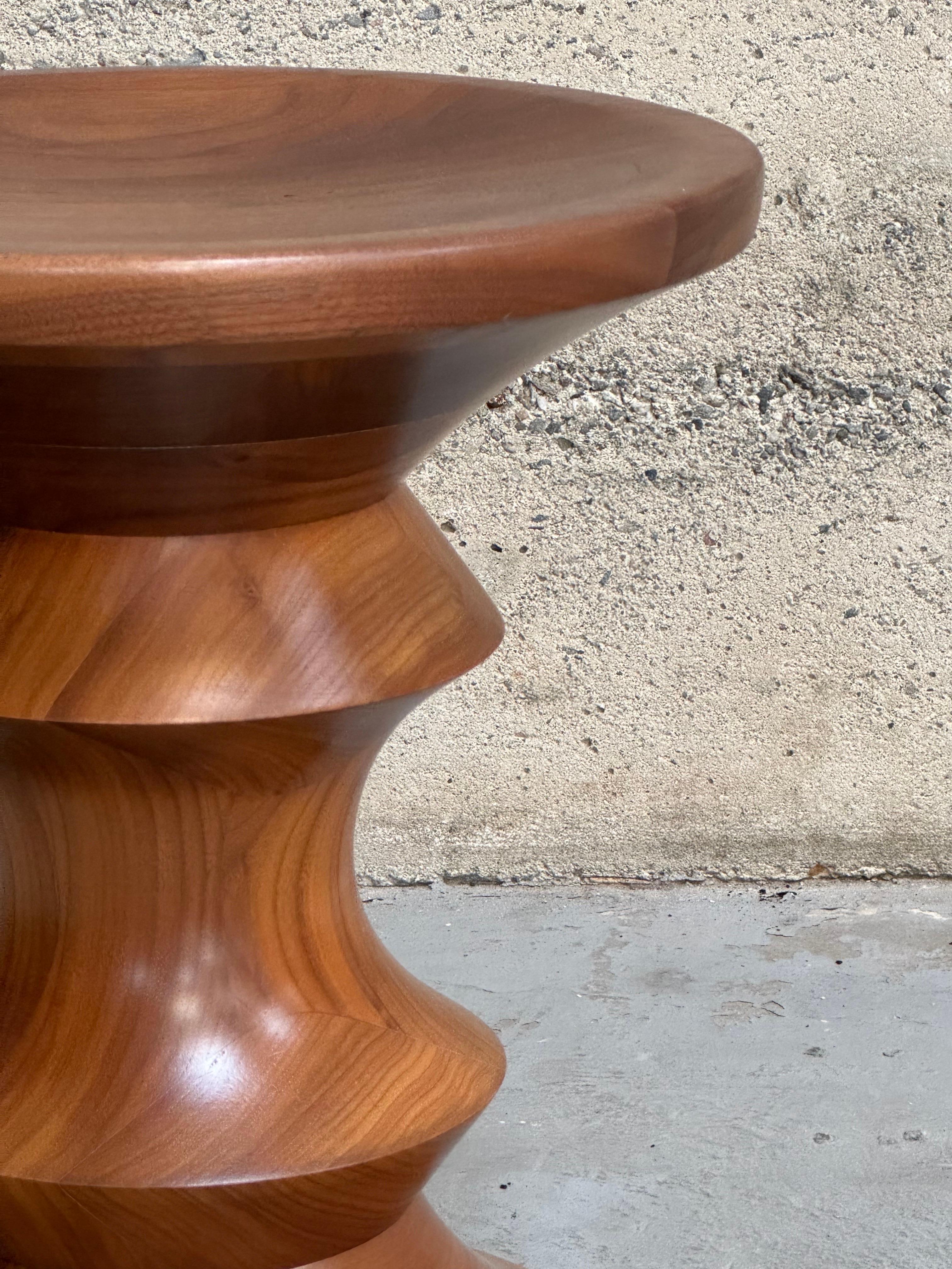 Times Life stool model A designed by Ray and Charles Eames for the Time Life Building during the 1950s, crafted from turned solid walnut. These are newer production pieces, rich color and graining.