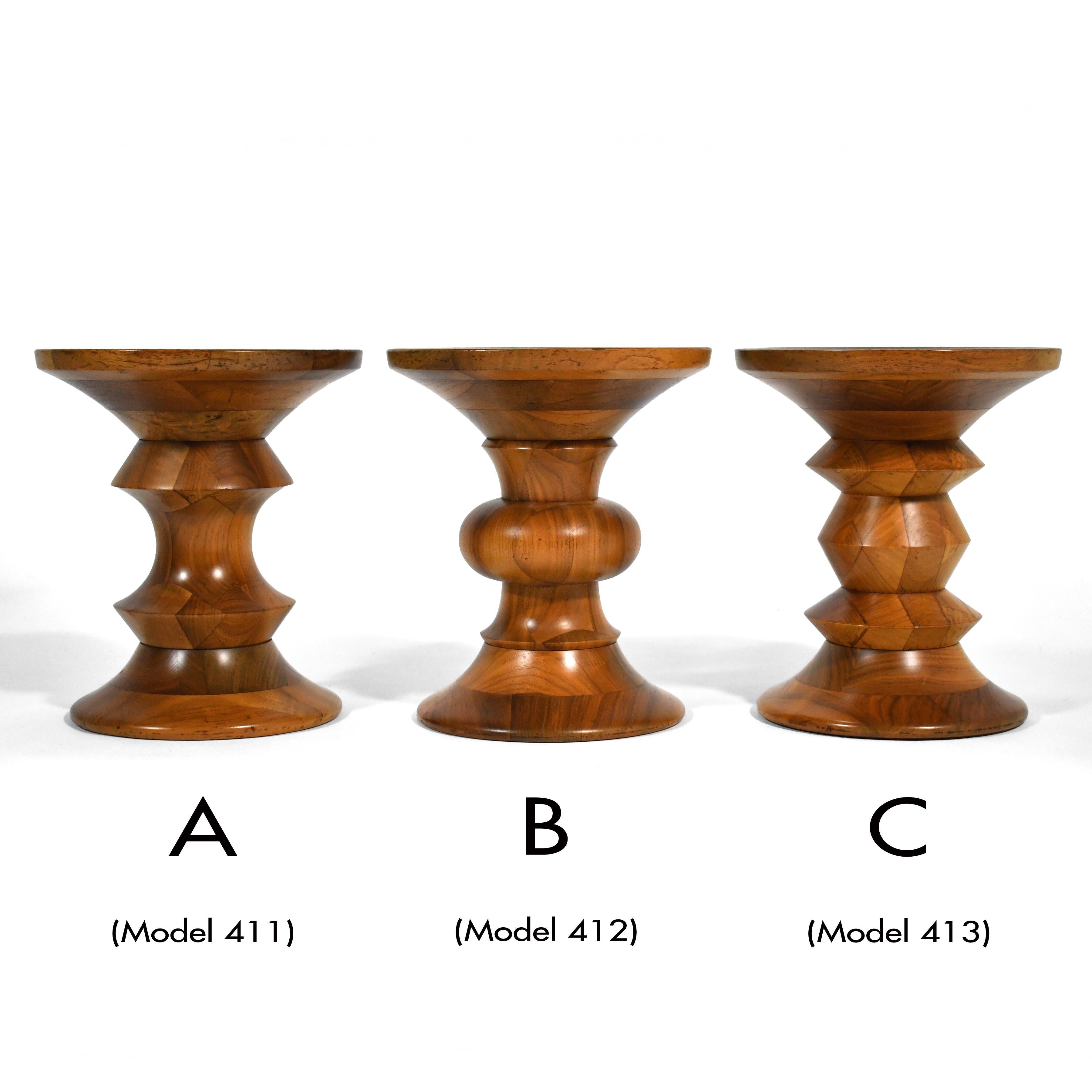 A complete set of vintage walnut stools designed in 1960 by Charles and Ray Eames for the Time-Life building and made by Herman Miller. These beautiful, solid wood sculptural pieces are perfect for occasional seating and can also serve as a low side
