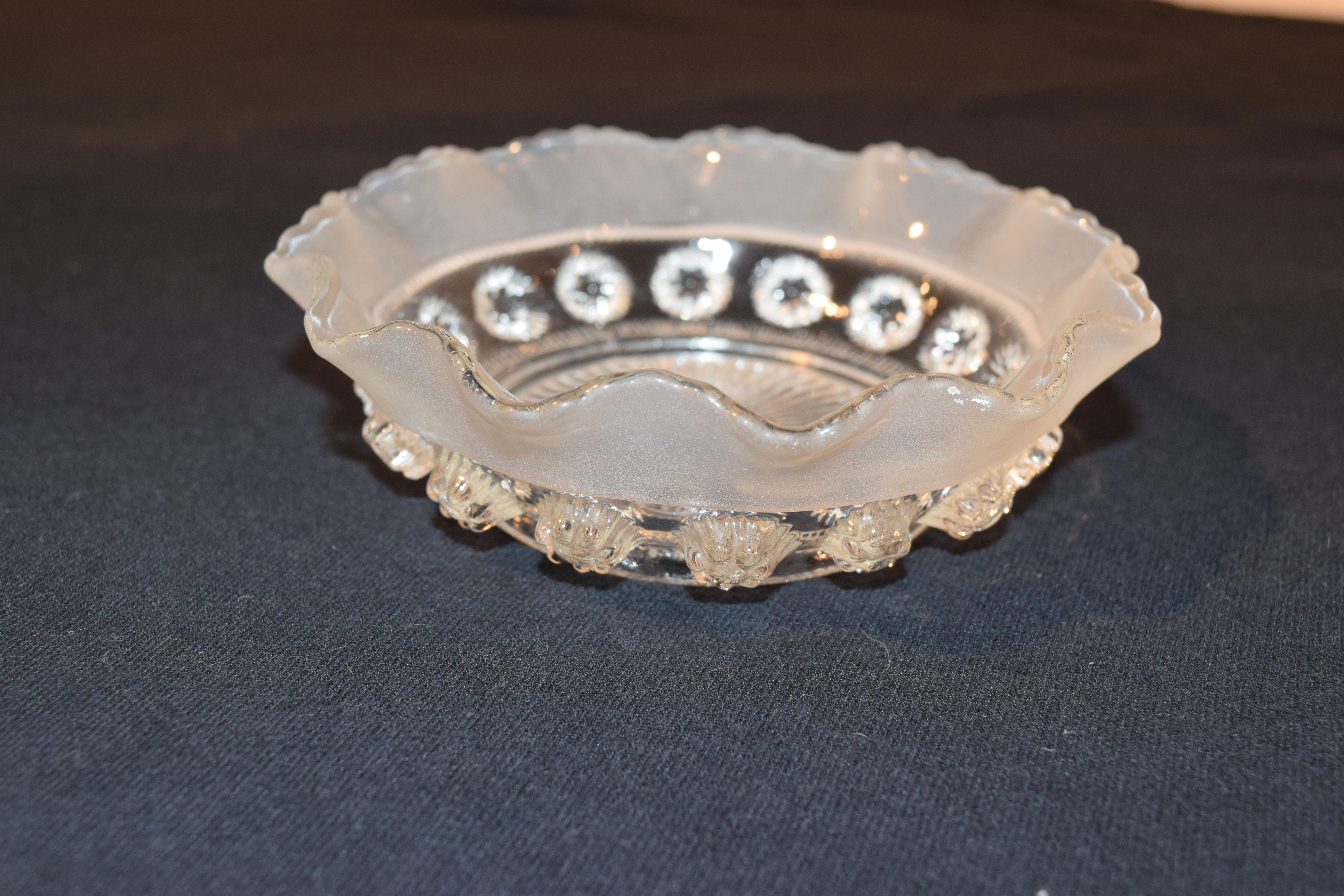 Late 19th century early American pressed glass small bowl with a lovely ruffled and scalloped edge with a starburst pattern in the center and applied glass buttons around the sides.