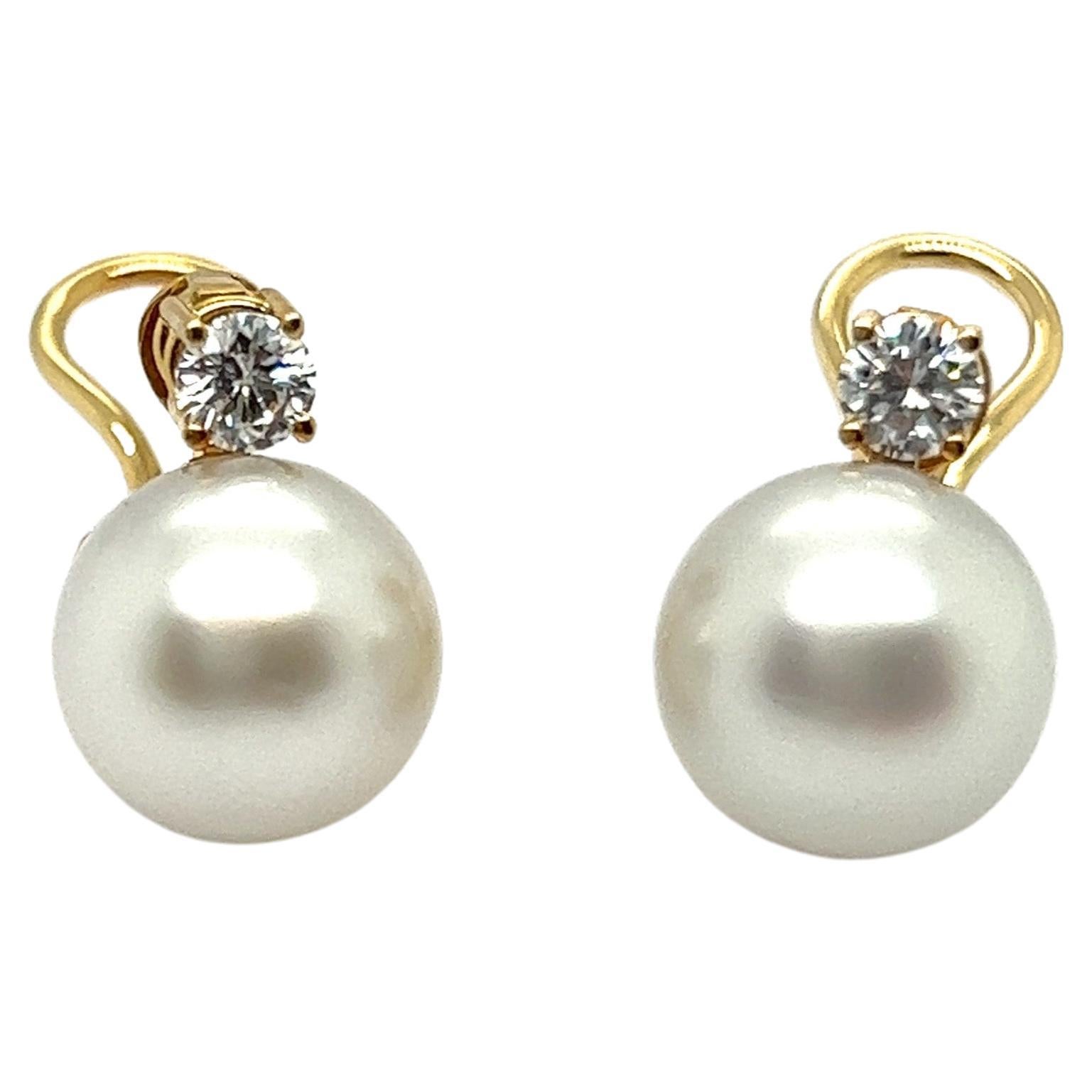 Explore the elegance of these classic ear clips with pearls and diamonds in 18 Karat yellow gold.

Capturing the spotlight are two round cultured South Sea pearls, evoking the delicacy of dewdrops in a lavish white hue. Paired alongside are two