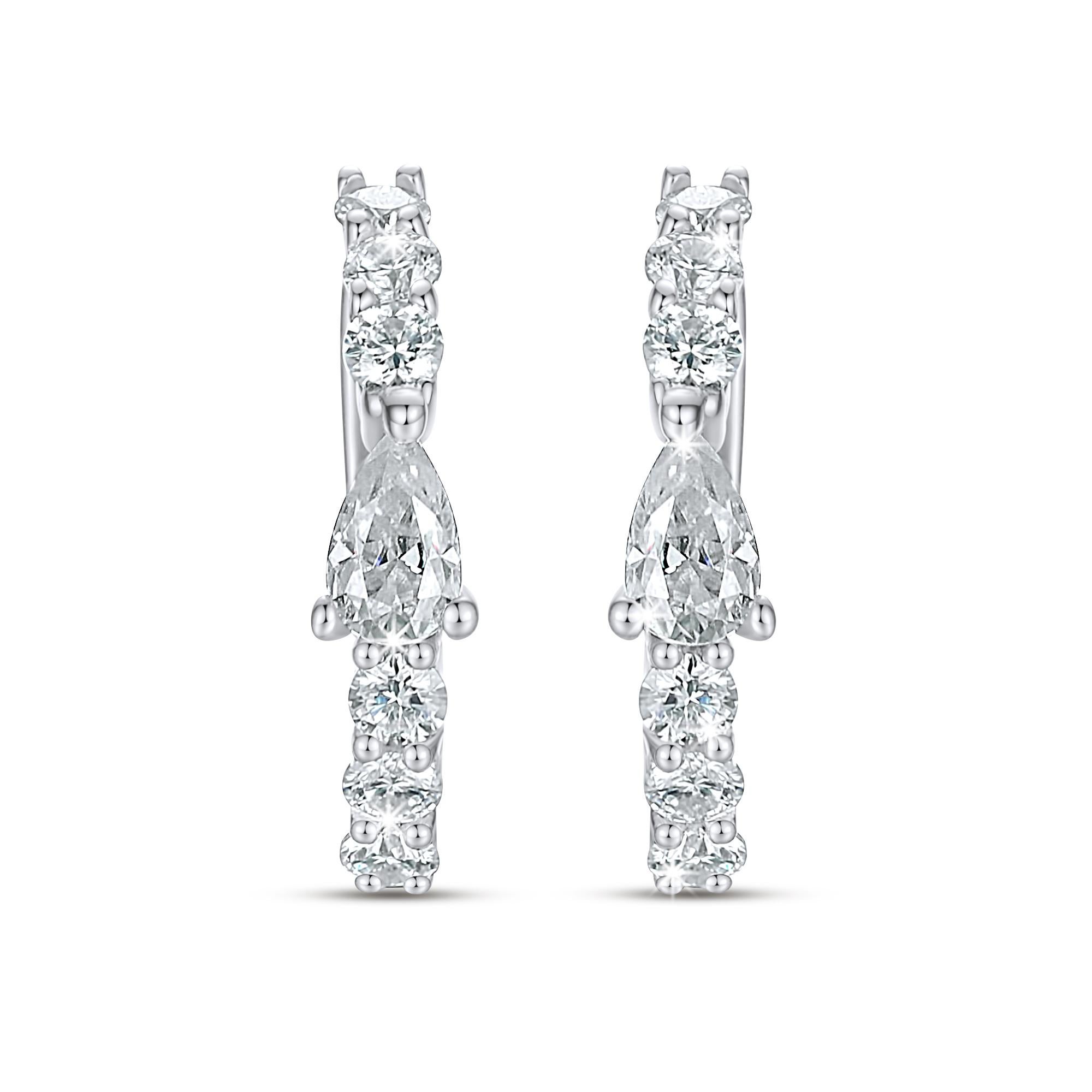 Enjoy sublime levels of sparkle with the Romancing Huggie earrings. A scintillating row of Natural channel set diamonds is topped off with an elegant cluster at the clasp. Celebrate your divine femininity by styling these 14K gold diamond huggie