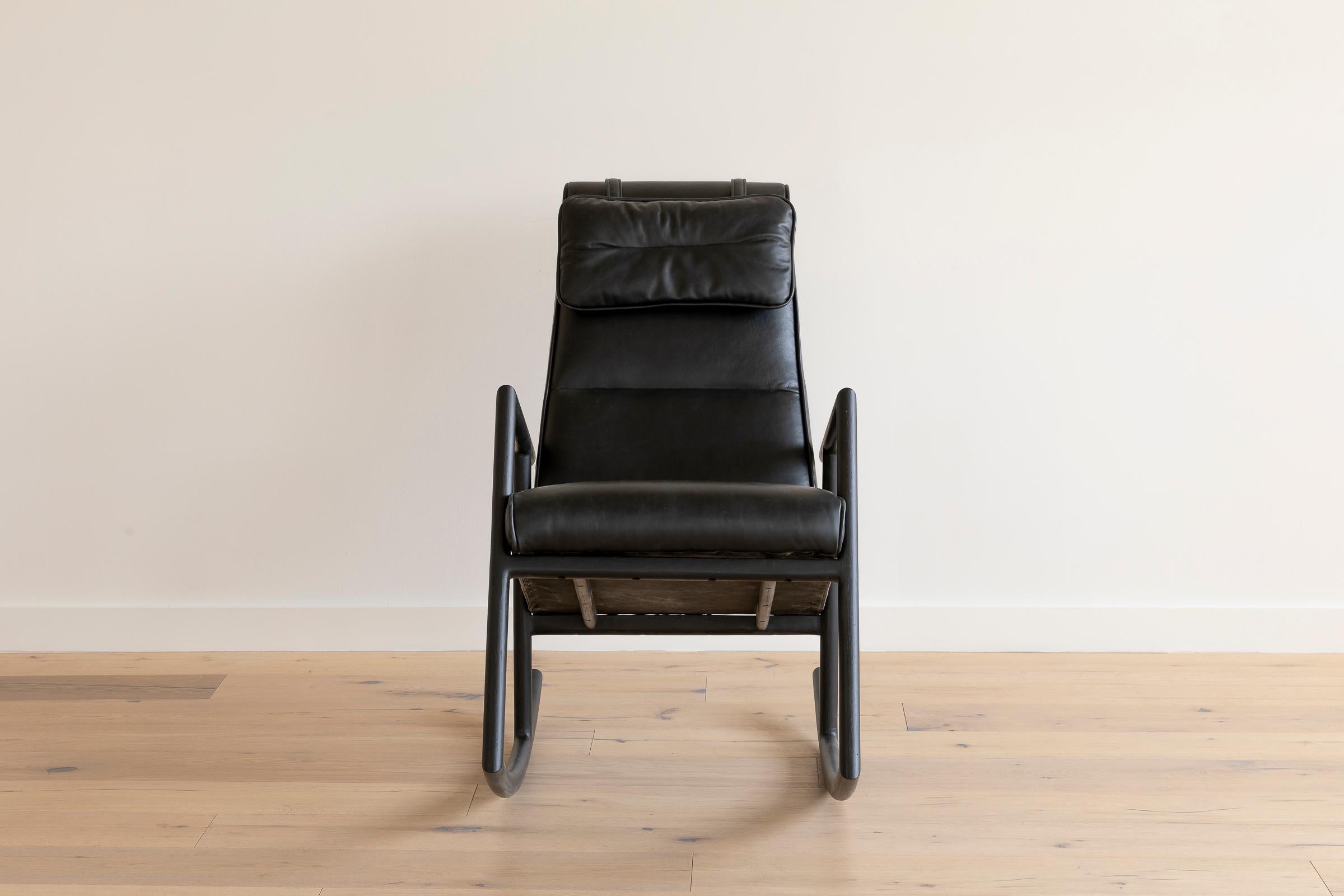 Solid wood construction with hand-cut joinery and custom upholstered seat and seat back. This Rocker shown in ebonized oak and black leather.

In stock leather choice: black, olive, camel or vegtan leather.
Wood choice: ebonized oak, walnut,