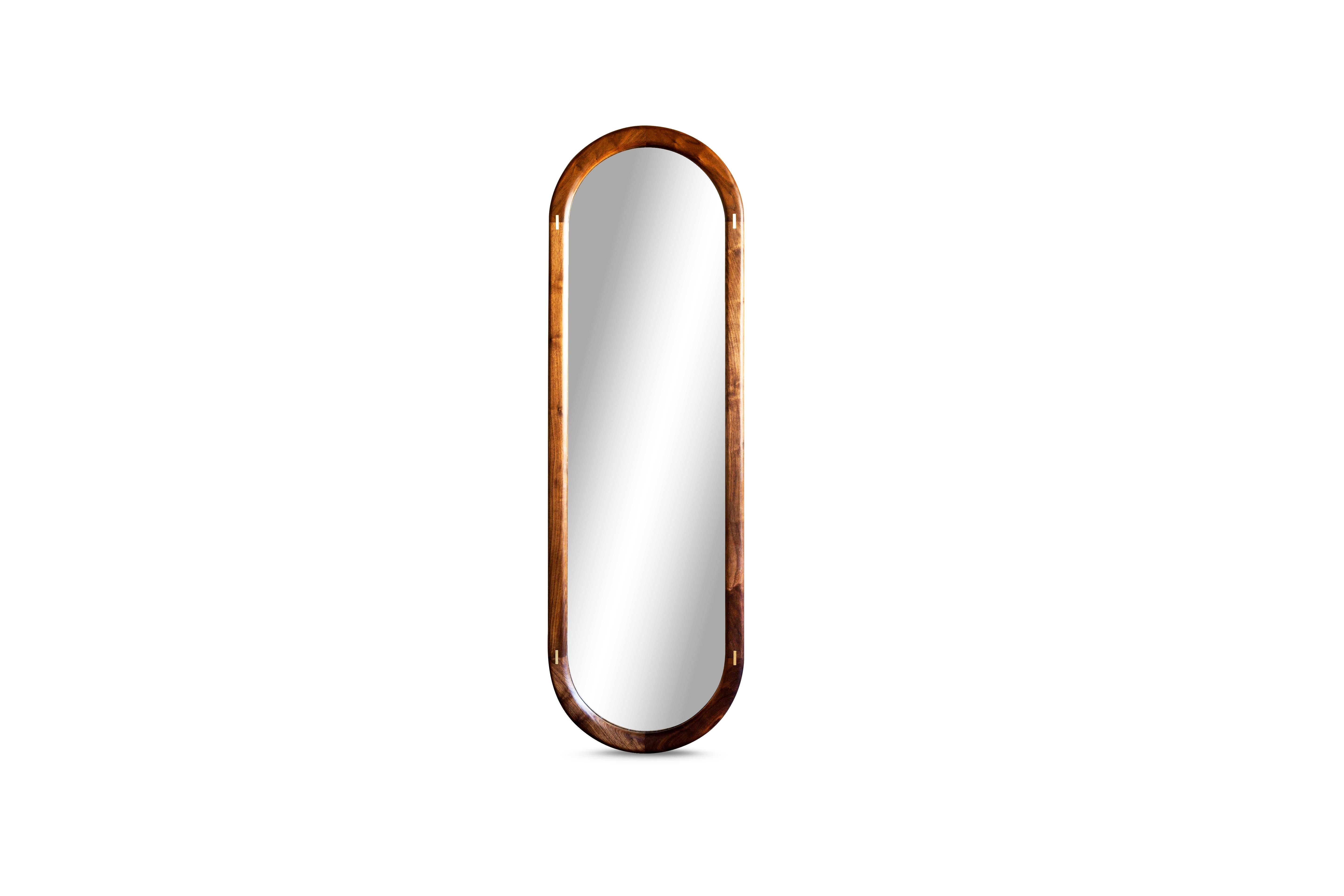 Solid wood constructed pill shaped mirror with true metal inlay detailing.
This mirror is shown in walnut with a brass inlay.

We are currently making these in two sizes:
20” W x 64” H x 2” D
30” W x 40” H x 2” D.

 
