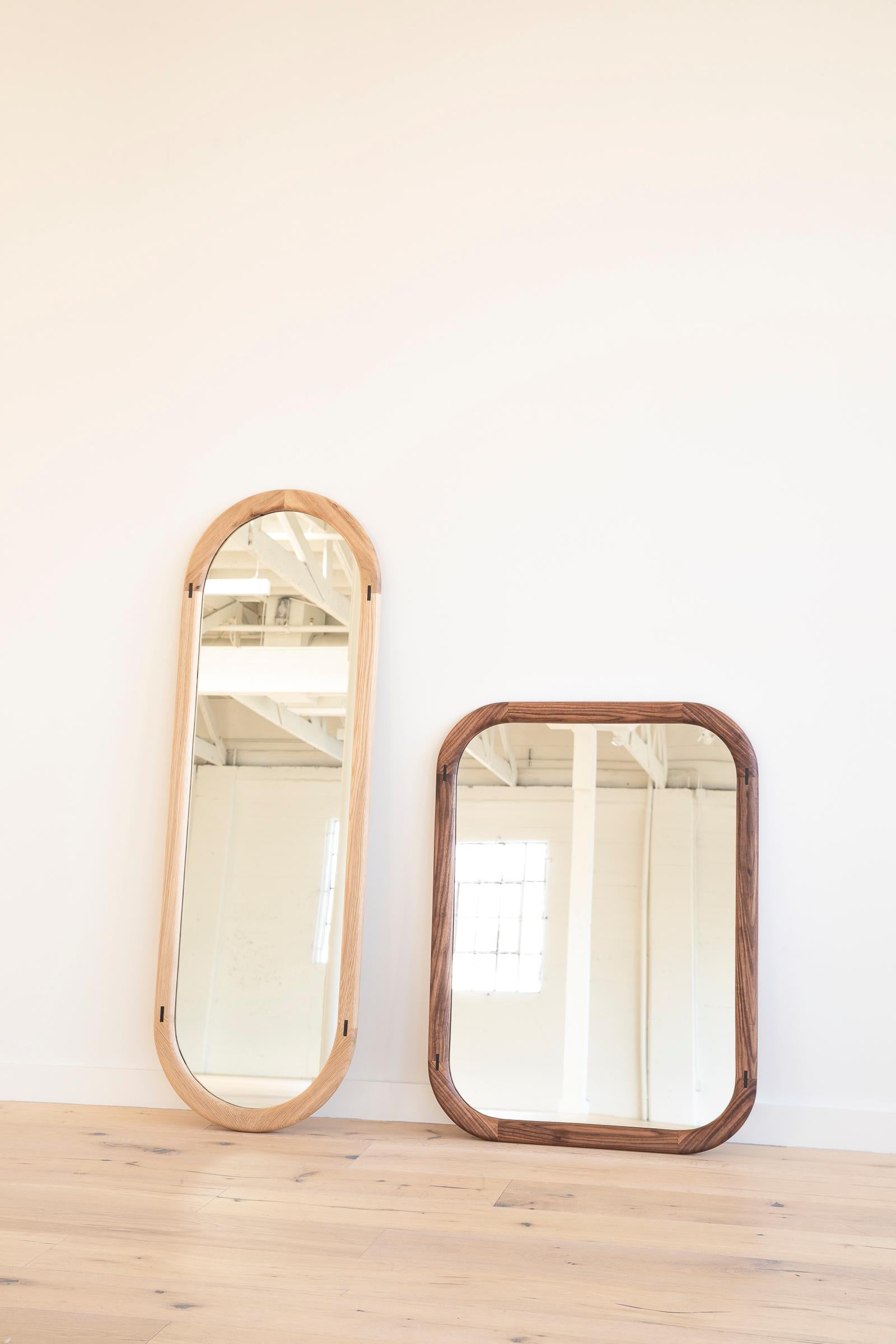 Solid wood constructed pill shaped mirror with true metal inlay detailing.
This mirror is shown in walnut with a brass inlay.

We are currently making these in two sizes:
20” W x 64” H x 2” D
30” W x 40” H x 2” D.

 