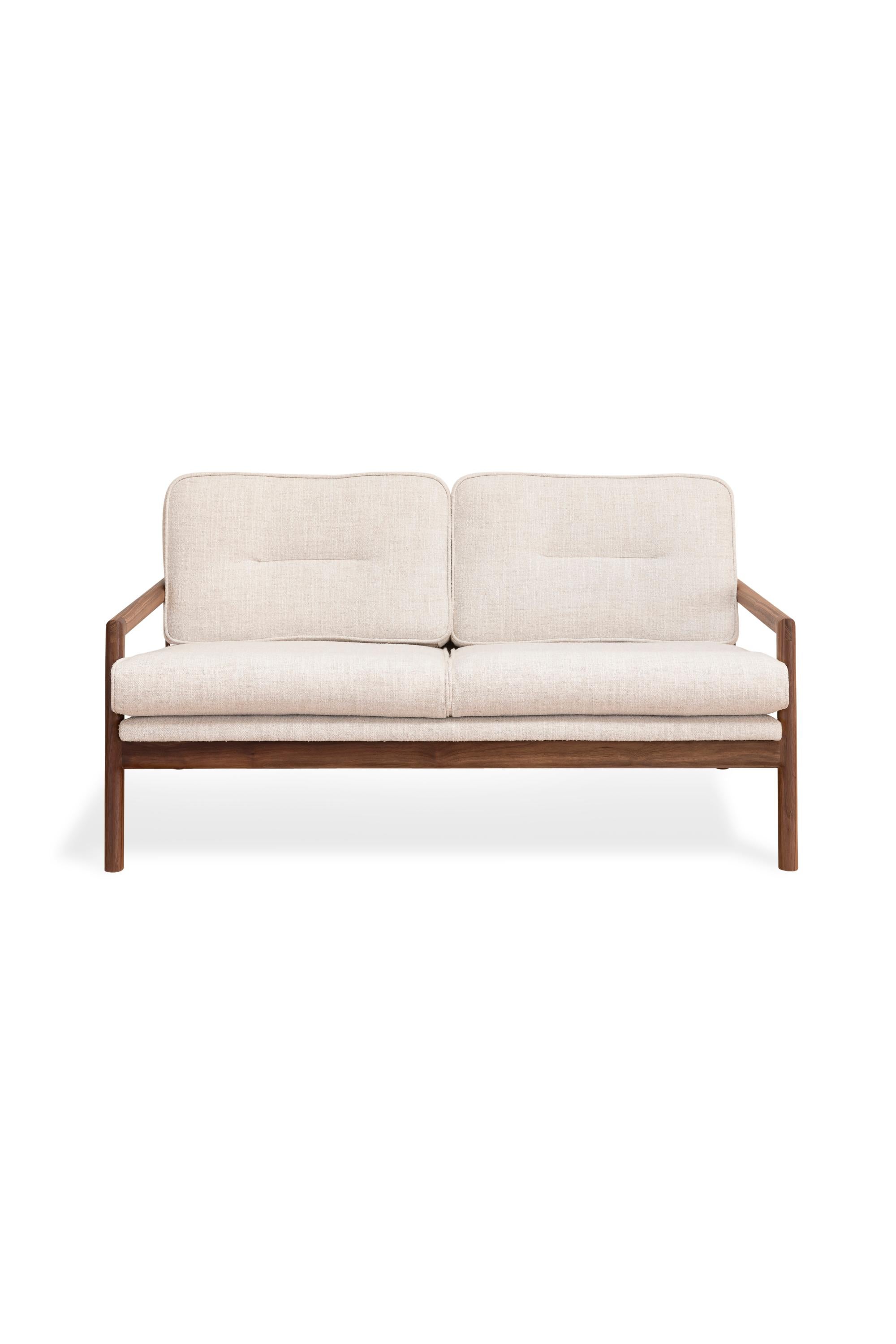This handmade solid wood constructed sofa includes handcut joinery and custom upholtered seat and seat back cushions.

This sofa is shown in our in maharam plume ciabatta ivory textured linen with a walnut frame.
Most Maharam upholstery fabrics