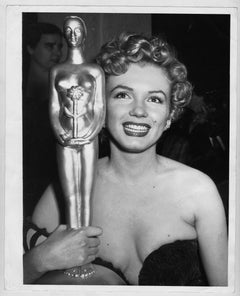 Actress Marilyn Monroe wins a trophy, 1952. Photographed by Earl Leaf