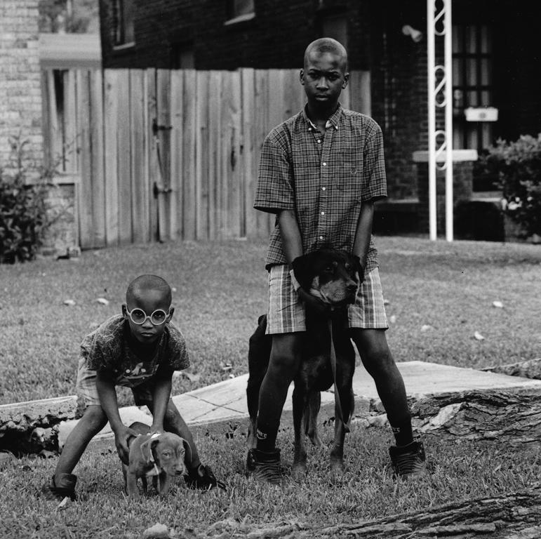 Earlie Hudnall Jr. Portrait Photograph - 2 Boys, 2 Dogs, 3rd Ward, Houston, Texas