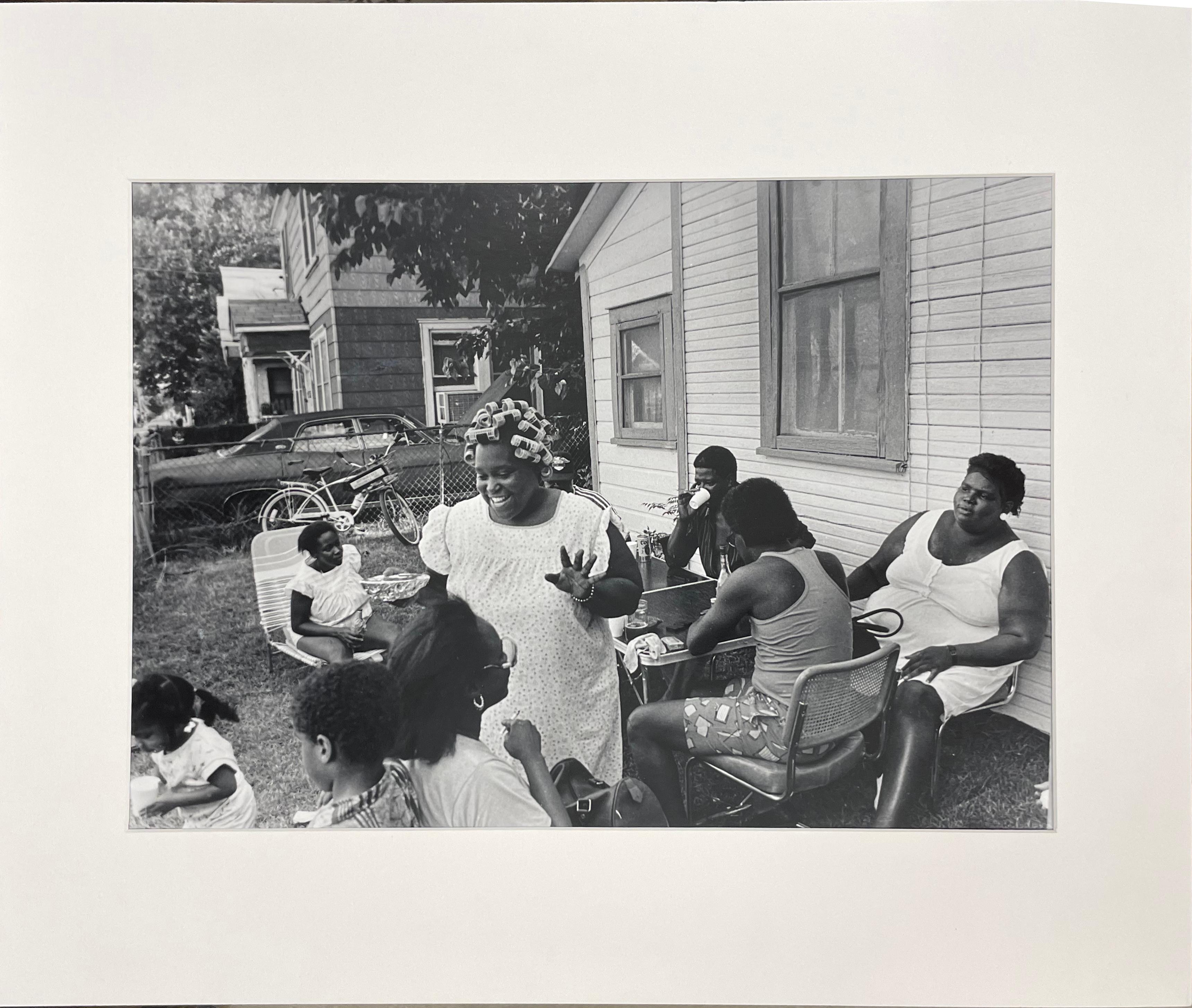 June 19th by Earlie Hudnall, Jr., is a black and white photograph documenting a family's celebration of Juneteenth, the day in which the last of the enslaved people in Texas were told of their freedom through the Emancipation Proclamation. 
This