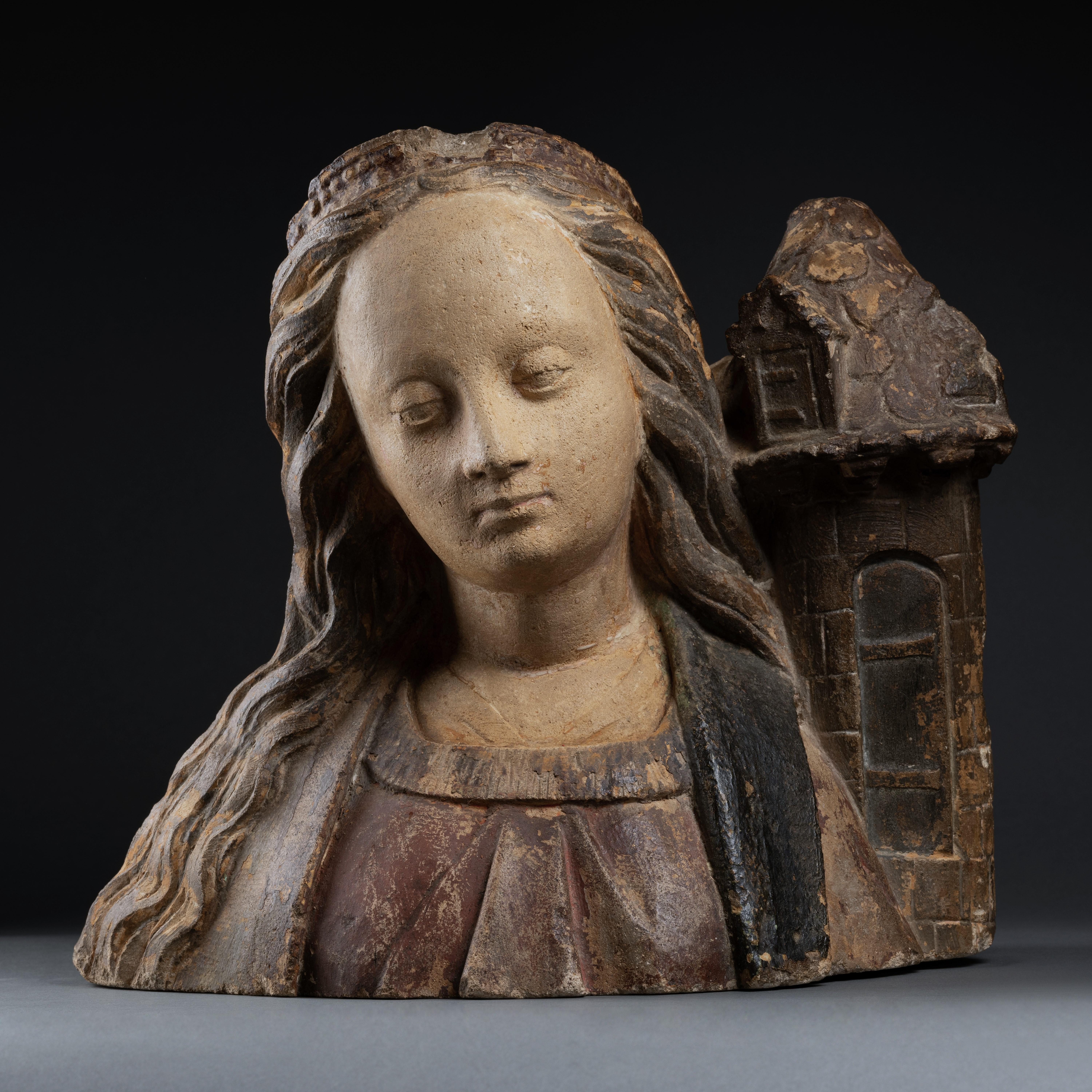 Bust of Saint Barbara 
School of Troyes, Champagne
Circa 1520-1530
Partially polychrome limestone
h. 13 in., w. 12.6 in., d. 9.84 in.

This remarkable stone sculpture belongs to the traditional Champagne repertoire from the first third of the 16th