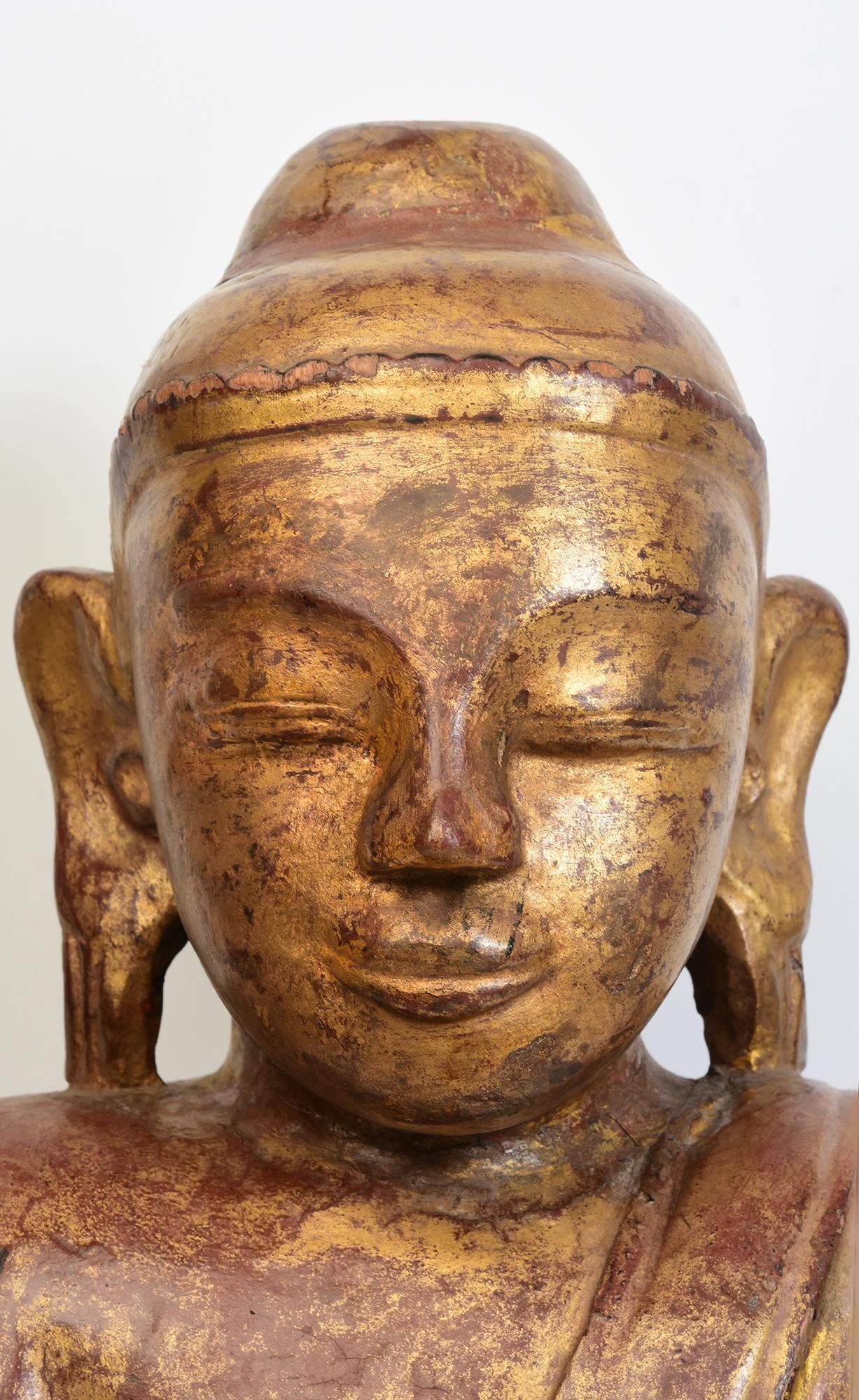 Antique Burmese wooden Buddha sitting in Mara Vijaya (calling the earth to witness) posture on a lotus base.

Age: Burma, Early Shan Period, Early 16th Century
Size: Height 53.4 C.M. / Width 34.3 C.M. / Depth 23 C.M.
Condition: Nice condition