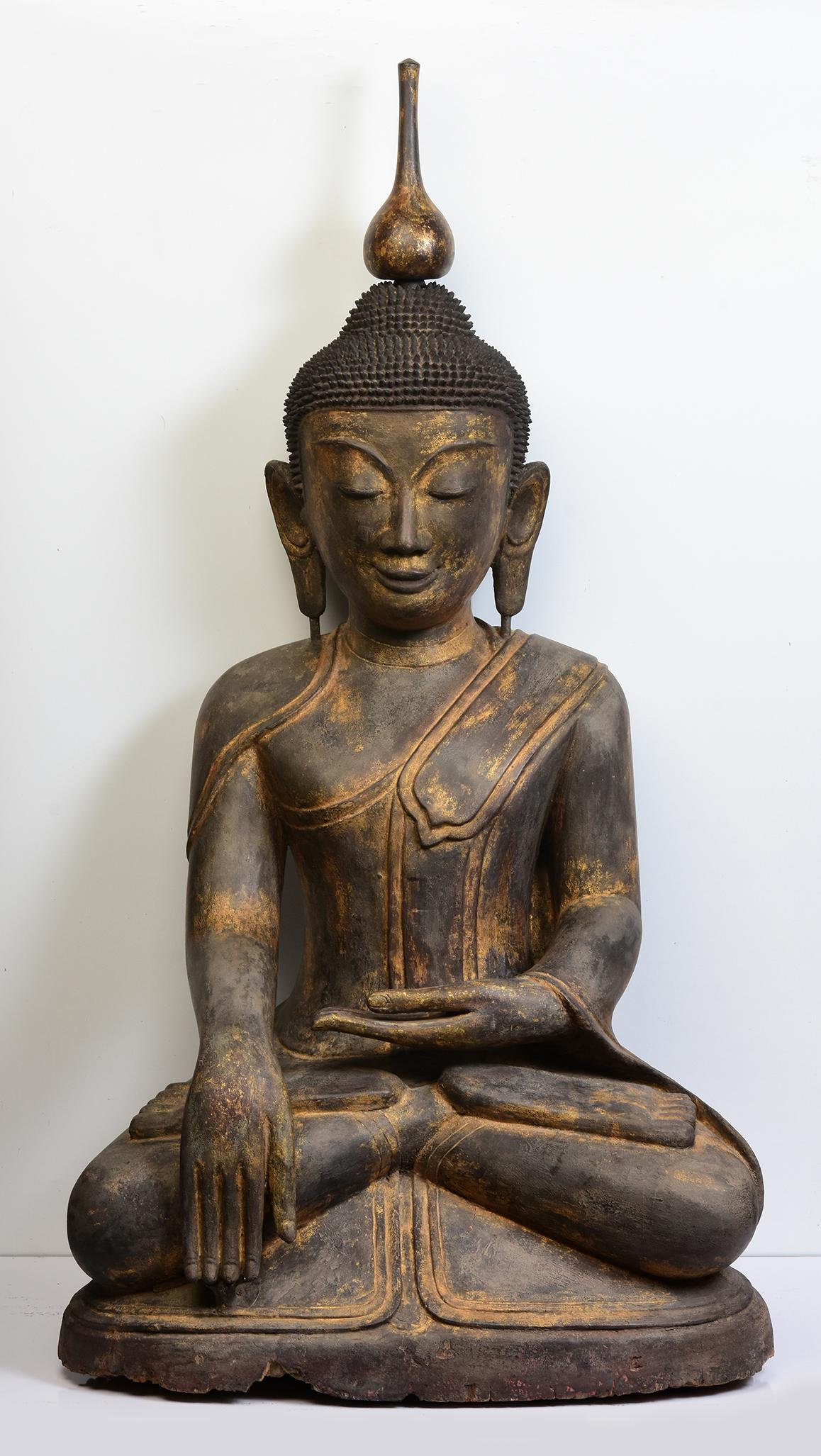 Antique large Burmese wooden Buddha sitting in Mara Vijaya (calling the earth to witness) posture on a base.

Age: Burma, Early Shan Period, Early 16th Century
Size: Height 123.8 C.M. / Width 69.5 C.M. / Depth 49 C.M.
Condition: Nice condition