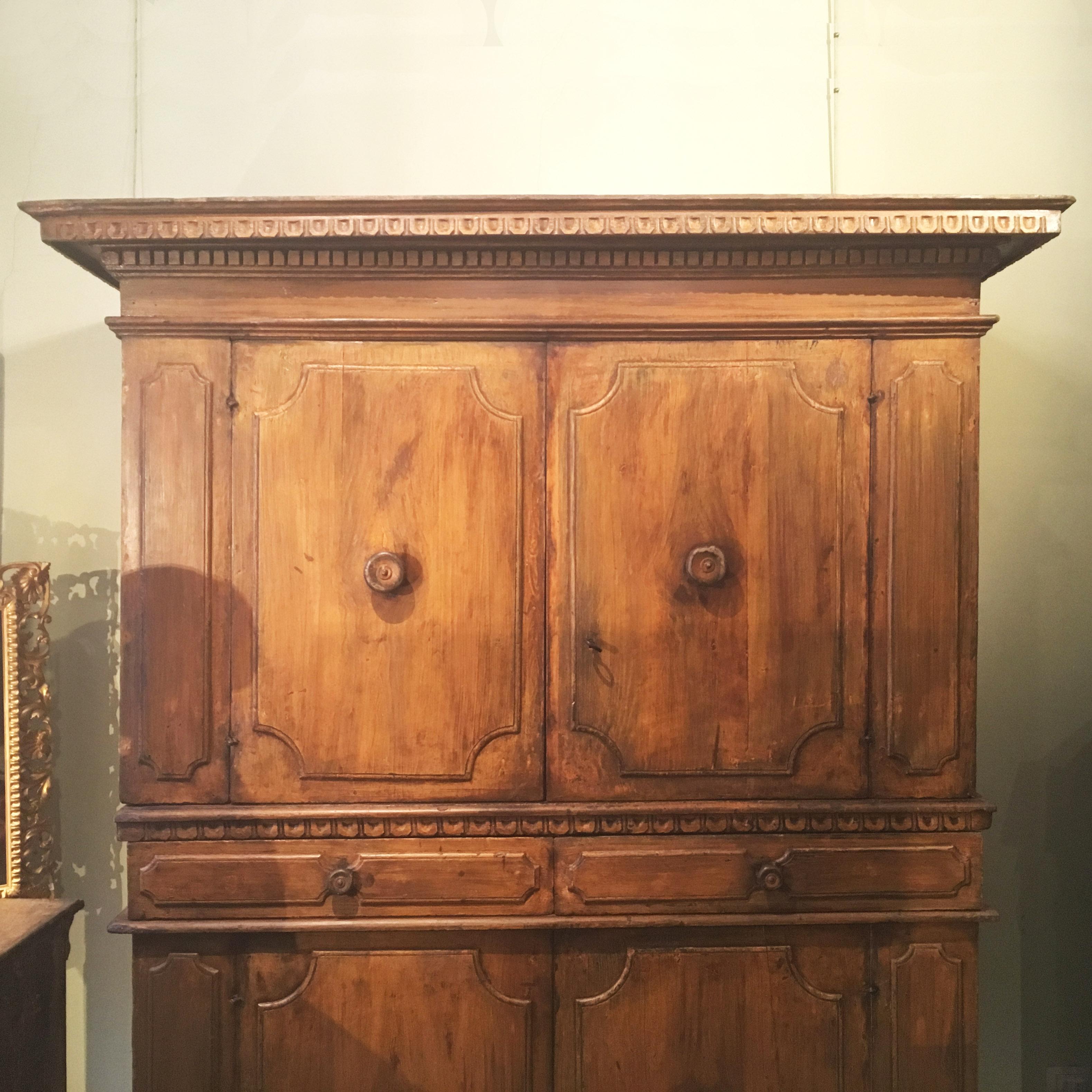 Charming Italian double body storage piece, with a total of four doors and drawers.
The oakwood cabinet is preserving its original painted surface and presents a typical carved decoration and style of Central Italian Renaisance furniture.
Bologna,