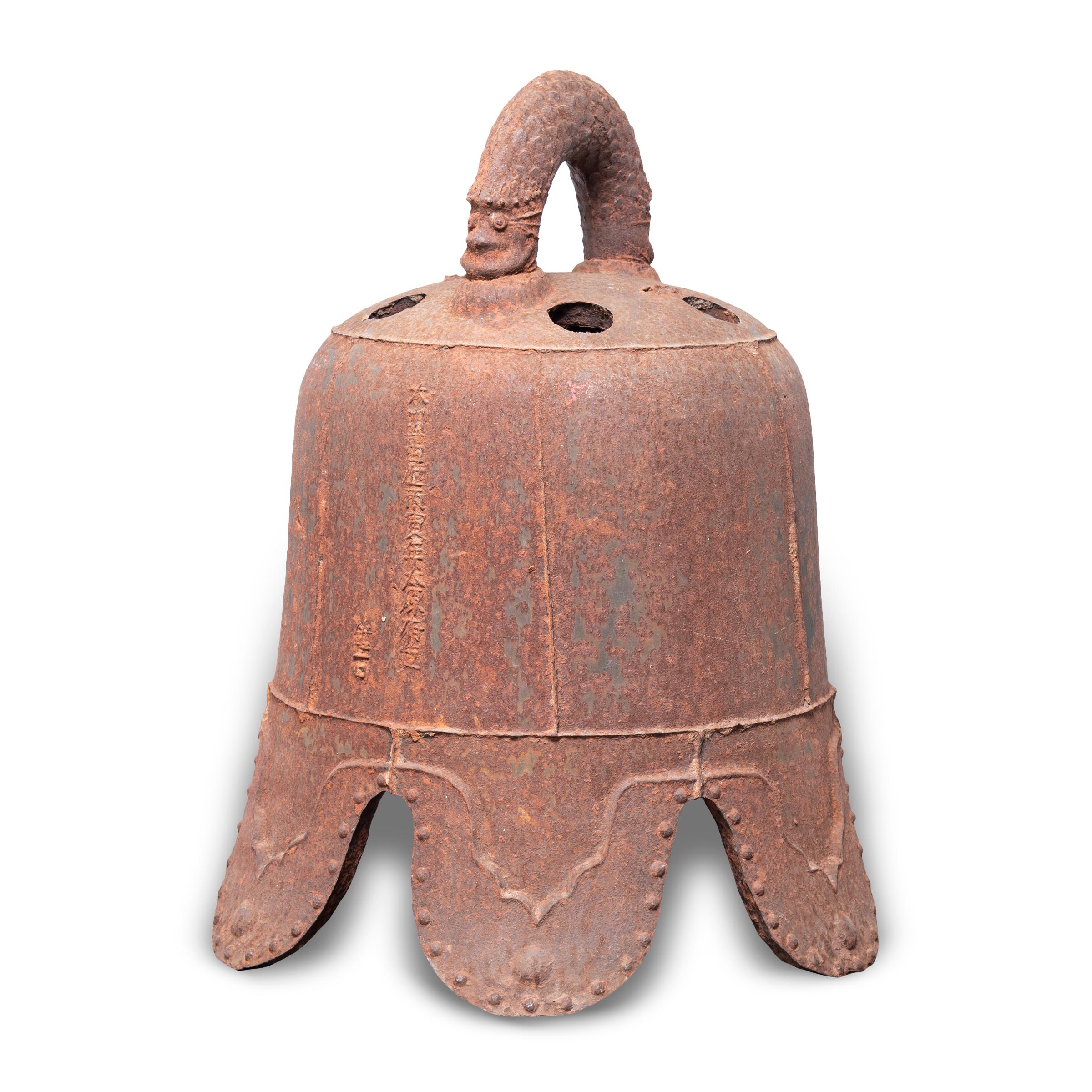 This monumental Ming-dynasty bell once pealed in a Chinese village, sounding out in celebration or giving notice of important events. Expertly forged, the cast-iron bell is detailed with characters in intricate relief, and its exaggerated scallop