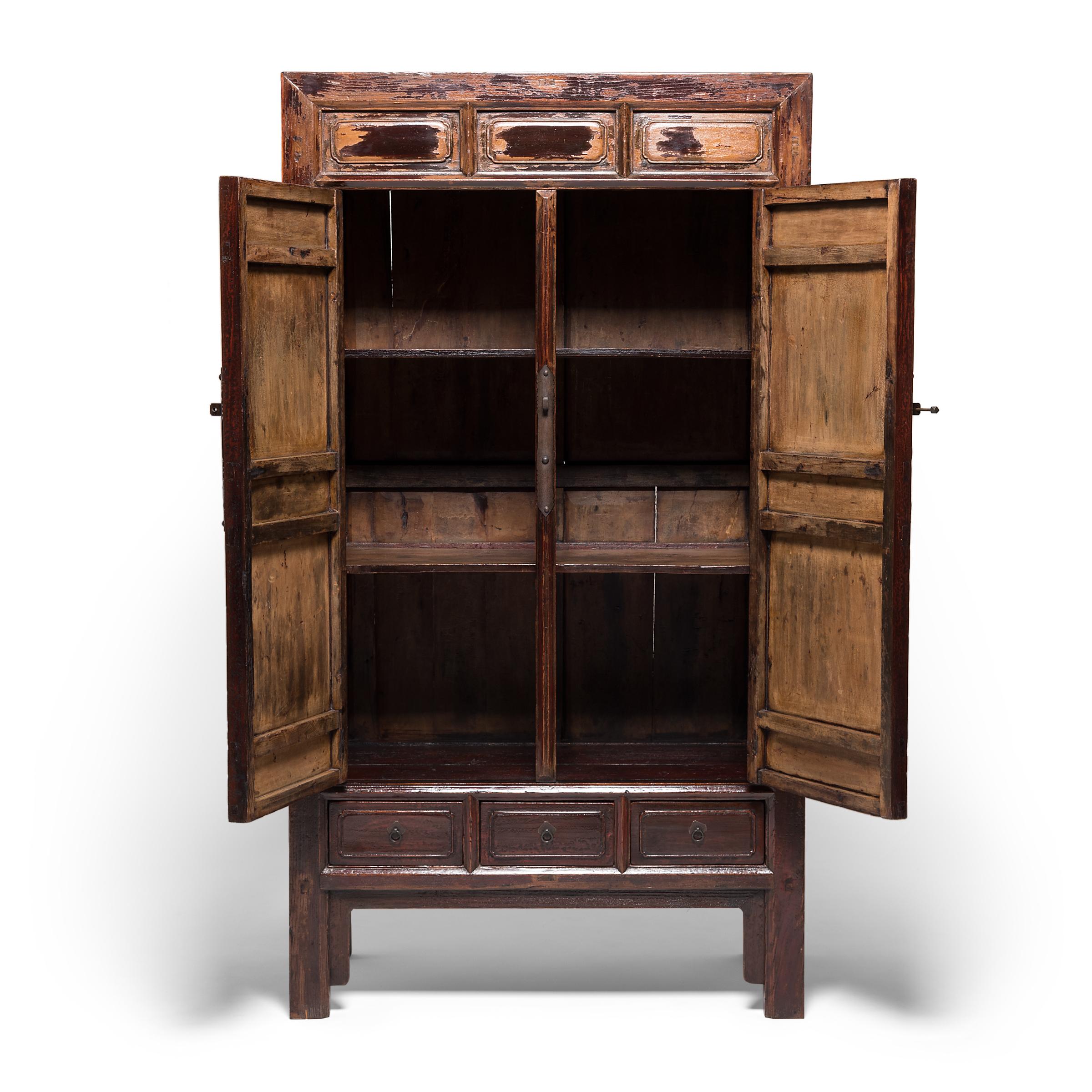 This is an exquisite example of a 17th century square corner cabinet, constructed with masterful mortise and tenon joinery. It features two paneled doors attached with small barrel hinges, a reference to traditional cabinets designs from thousands