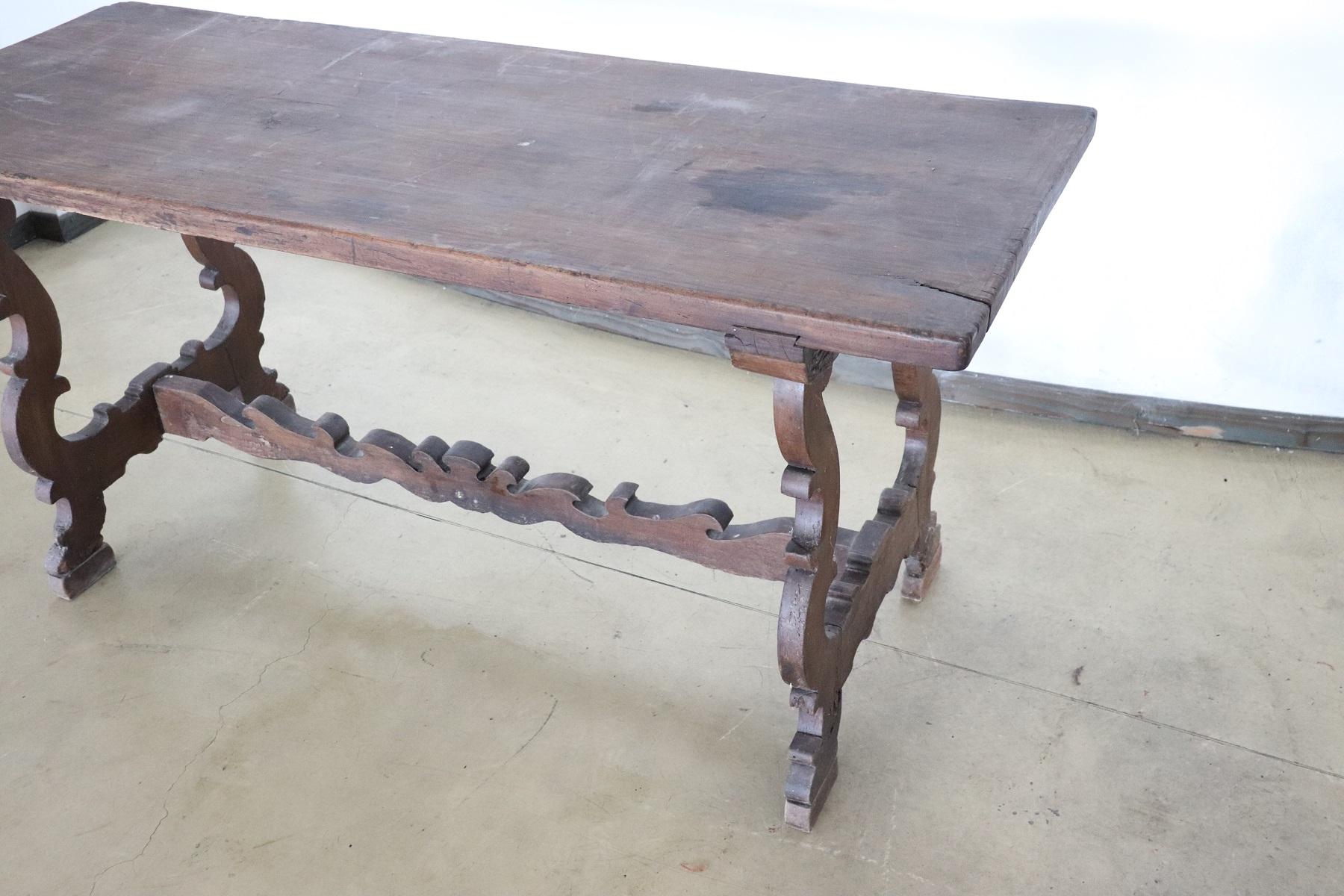 Important antique solid walnut table from the early 17th century. Walnut wood has acquired a beautiful antique patina presenting the signs of all the past centuries. This type of table in Italy was called 