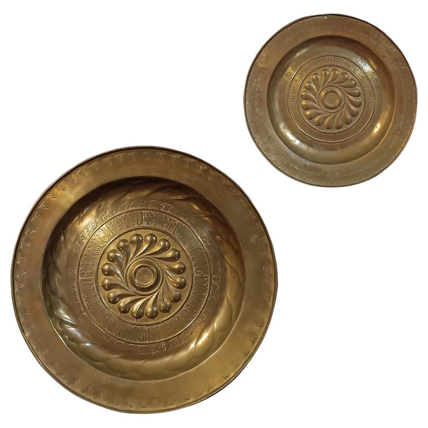 EARLY 17th CENTURY PAIR OF EMBOSSED BRASS ALMONERS