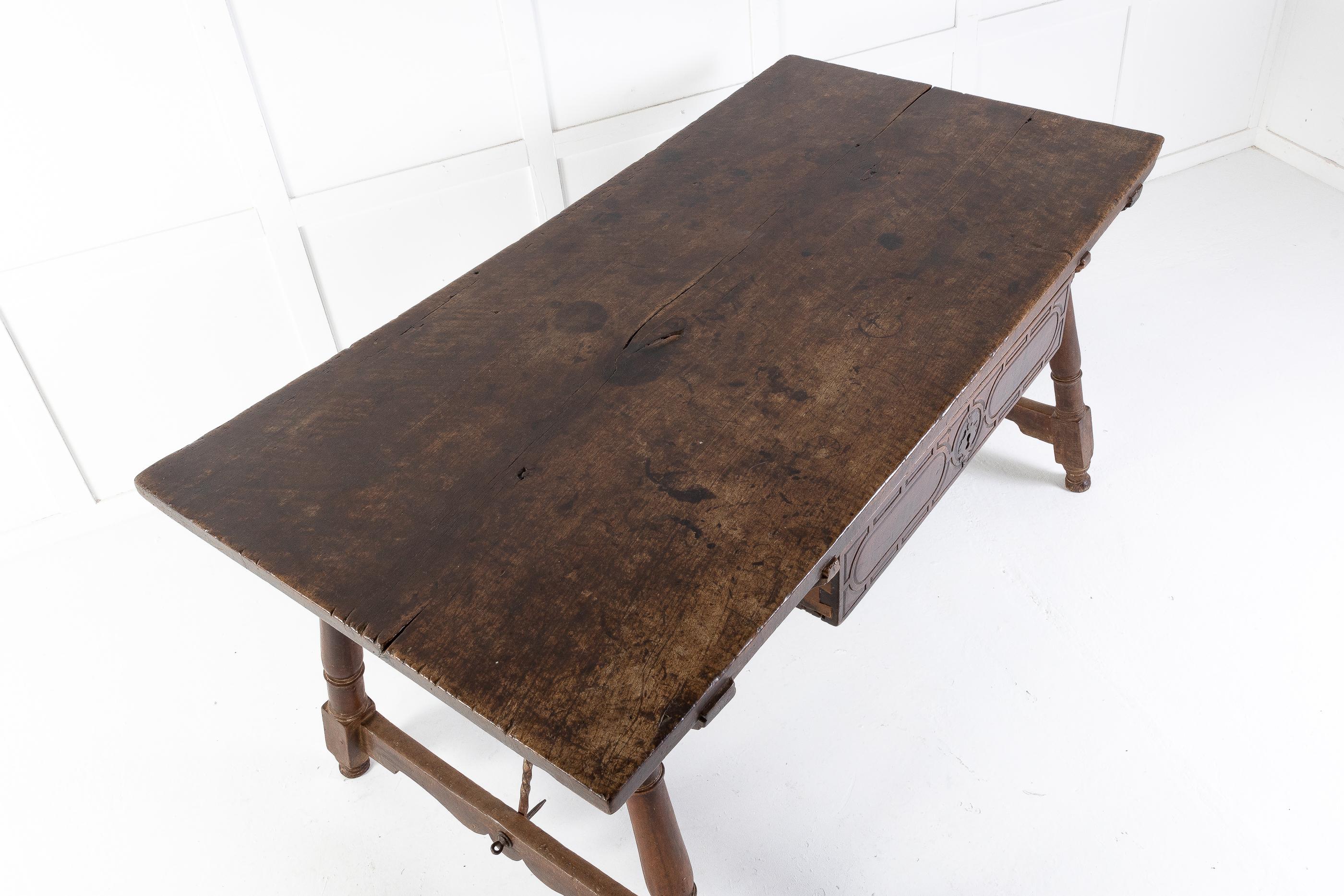 Magnificent large size, early 17th century Spanish table. The large, one piece top has the patination that in our opinion can’t be beaten. With a single beautiful patinated draw having its original lock. Also having original metal supports.

This