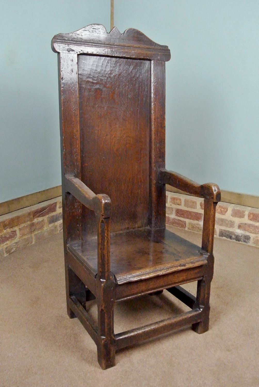 A very early and rare oak wainscot chair with a tall back and beautifully shaped crest. Peg jointed throughout. The arm supports and front legs are square sectioned with chamfered faces in the late 16th Century Elizabethan manner. 

Solid oak
