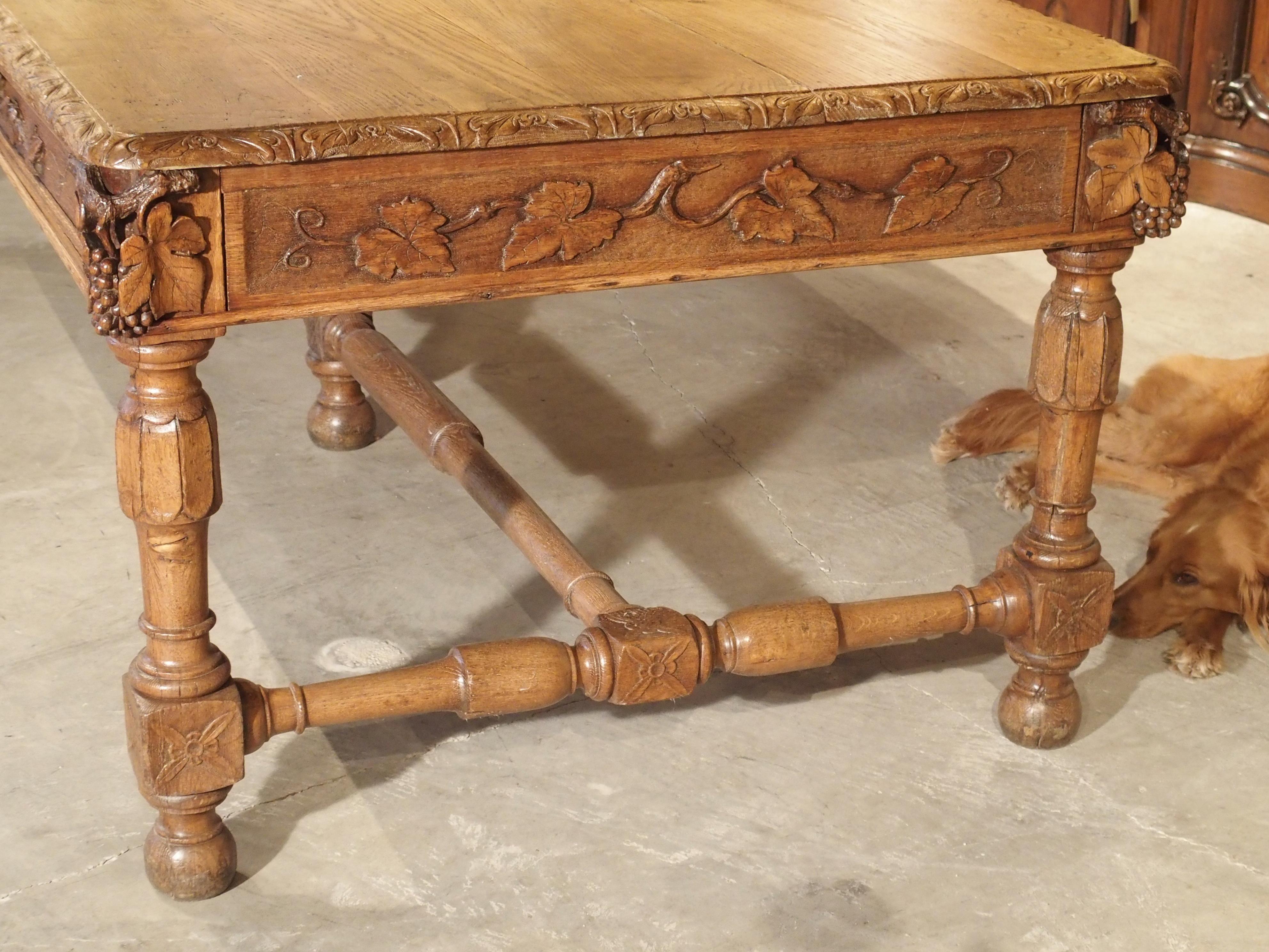 This versatile antique French table with its hand carved grape motifs can be used as a dining room table, library table, a centre table, hall table or, as a large desk. It was originally made as a tasting or presentation table in a French country