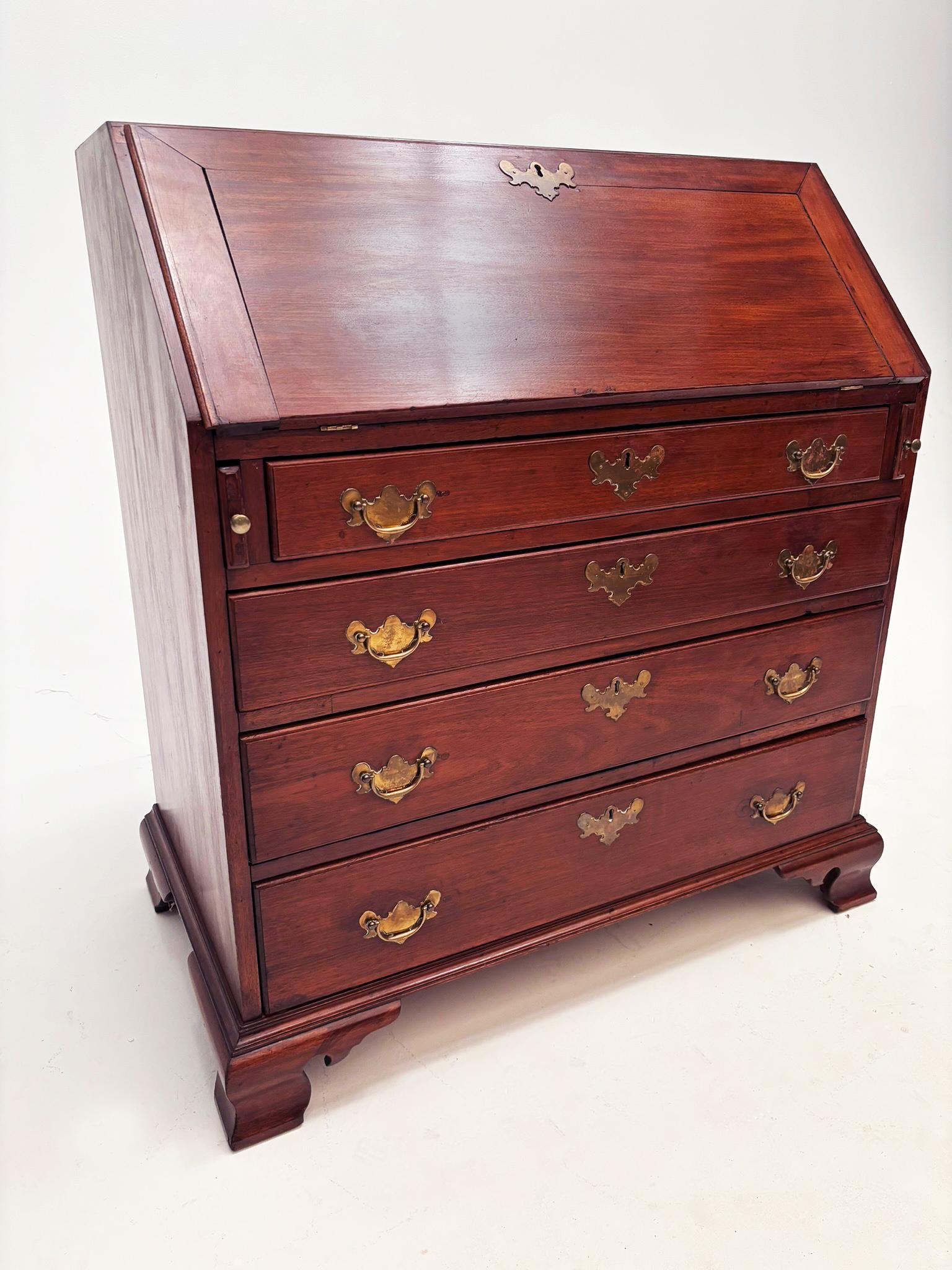 This early 19th century Georgian drop-front desk is reflective of an era when form and function paired beautifully to bring people amazing pieces. Made from gorgeous walnut this desk is comprised of 5 stacking drawers, constructed of oak,  the top