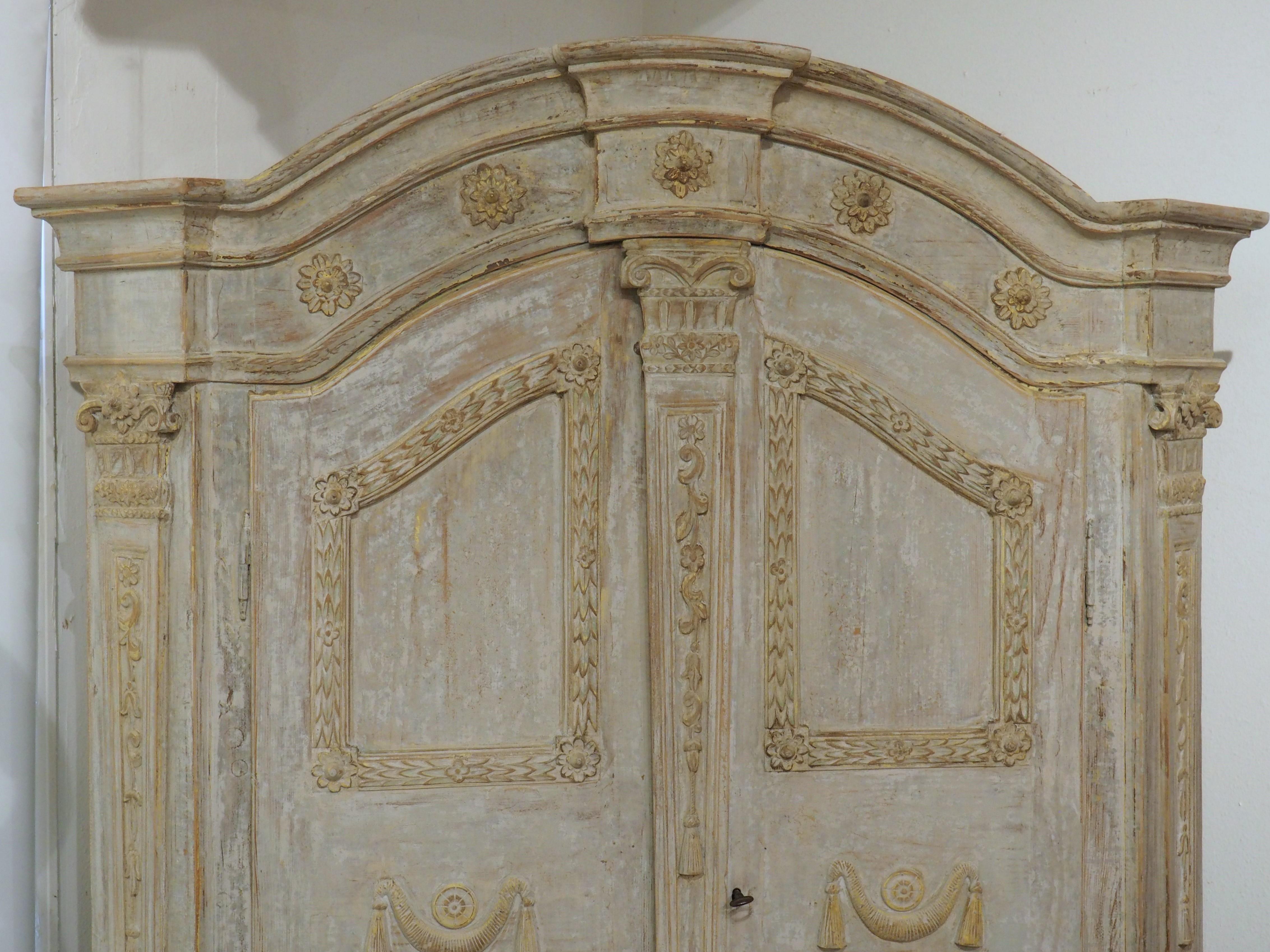 The intricacy of Baroque-style furnishings is on full display in the painted pine armoire from the early 1800s. Most likely hand-carved in Germany or one of the Scandinavian countries, the detailing of the moldings and pilasters is quite exquisite,