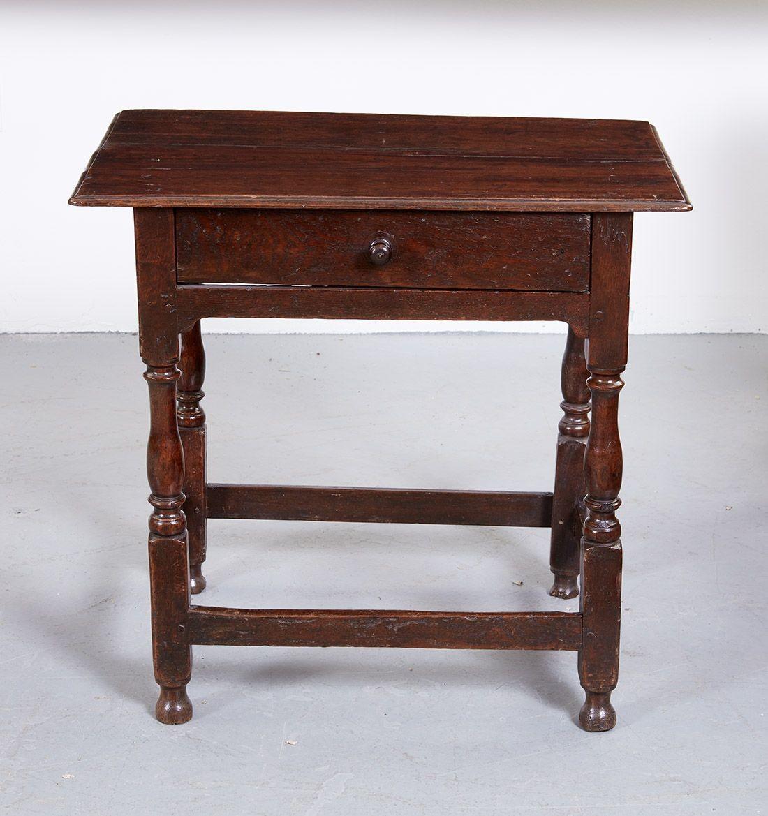 Early 18th century English oak single drawer side table, with thumb molded top over single drawer with wooden pull, over balustrade turned legs joined by box stretcher base.  Useful as an end table or as a bedside table.  